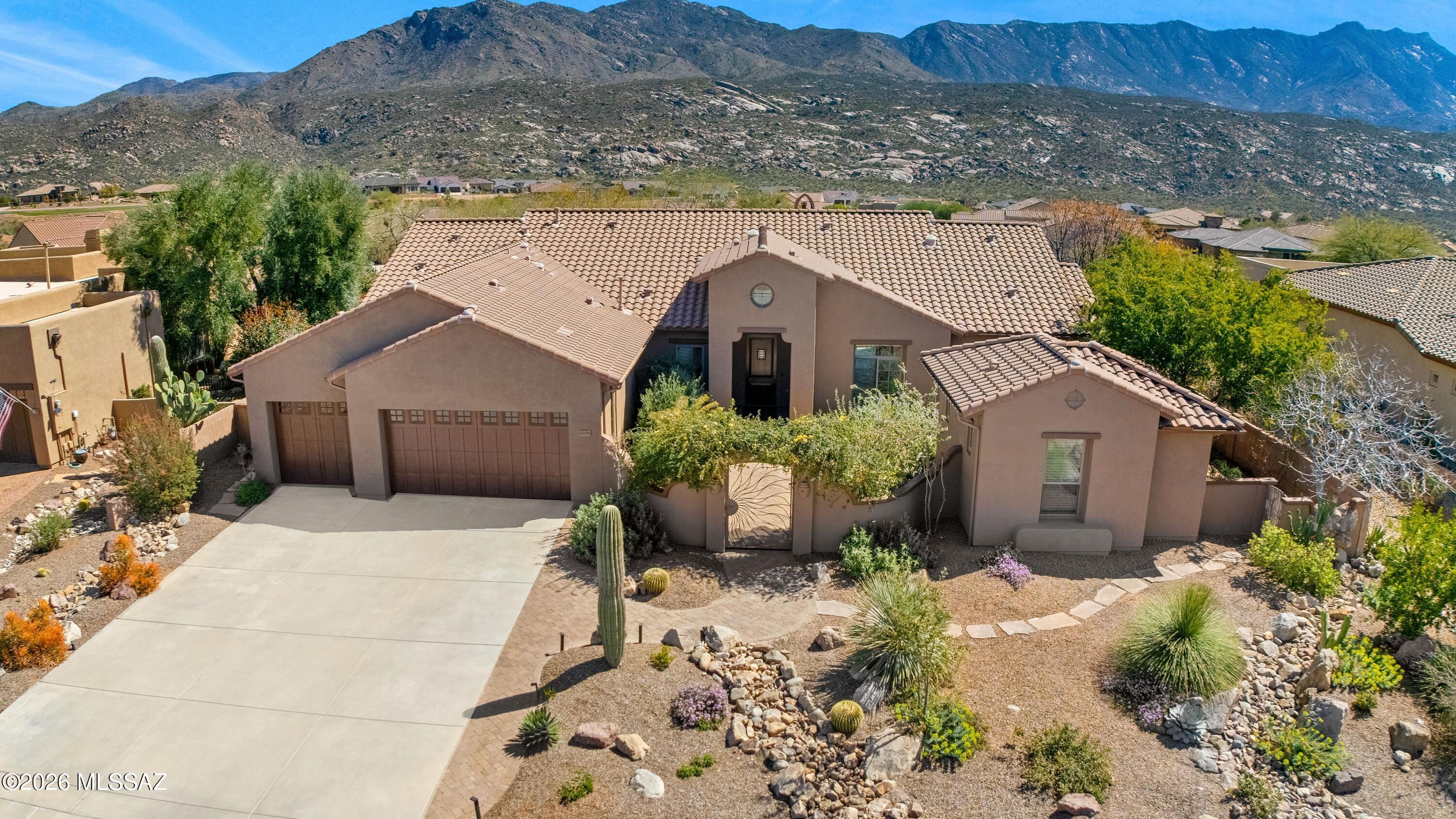 Located in the Preserve at SaddleBrooke, this Tierra with guest house captures sweeping, elevated golf course & mountain views in a truly private setting. Move in ready & meticulously maintained! Exterior painted in 2026 & roof underlayment replaced in 2022. Gated courtyard with fountain welcomes you inside. Great room features gas fireplace & windows framing panoramic views. Kitchen includes quartz counters, stainless steel appliances, gas cooktop, island, butler's pantry, & breakfast nook with patio slider. Owner's suite has flex room, patio slider, & ensuite bath with dual entry shower, soaking tub & 2 walk-in closets. 2 guest bedrooms share Jack & Jill bath. Powder room for guests. Laundry room has W/D, sink, & cabinets. Guest house has serving station, sink, refrigerator, & bath. Extended 3 car garage with cabinets. Covered patio, extended paver patio, beautifully landscaped & gated yard. Enjoy luxury living with gorgeous views & exceptional quality throughout.