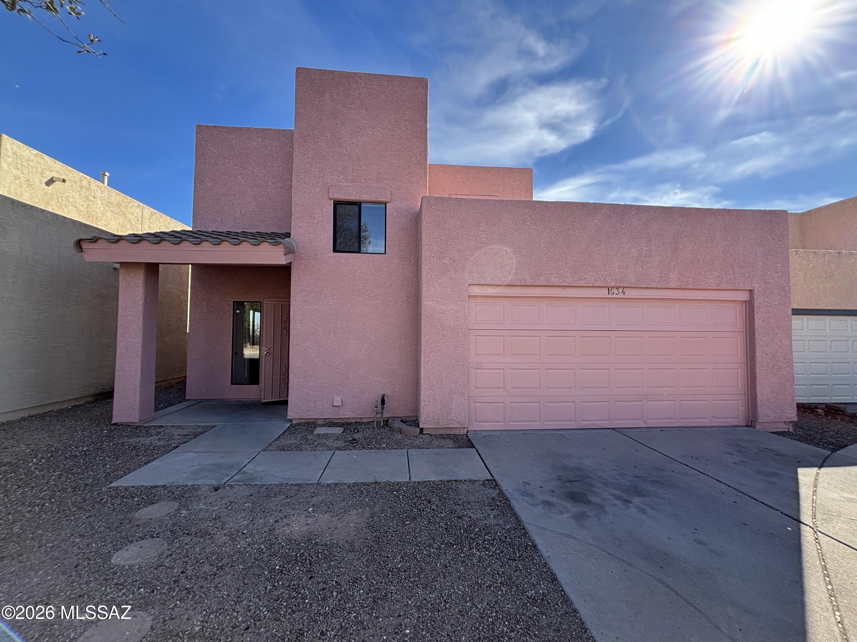 Home features AC, a two car garage, washer/dryer hookups, Good sized walled yard with a covered patio.  Full suite of appliances. Primary suite is on the first floor.  New carpet upstairs and ceramic tile downstairs. The seller is offering a 3% concession to the buyer with an accepted offer. That means he will give a credit of 3% of the purchase price. This credit can be used towards the buyer's closing costs or down payment. The credit can also be used to buy down or reduce the interest on the new mortgage interest rate by possibly 1% which can reduce the monthly payment by $175 or so . The credit can also be used to temporary buydown of 2% the first year & 1% the second year. Ask your lender for more information or contact Lance Dickson at Cross Country Mortgage. 520-975-8444