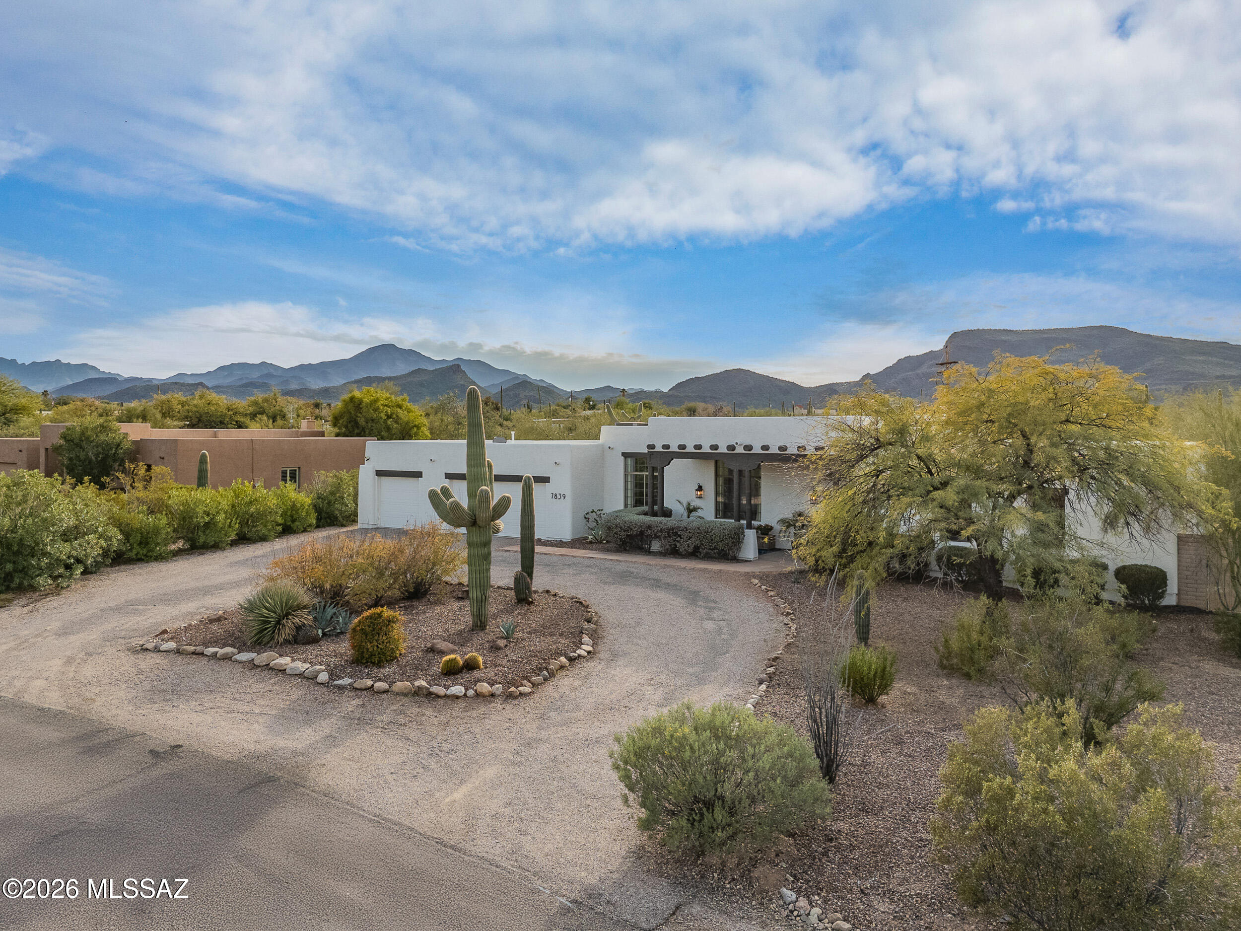 This elegantly remodeled 4-bedroom, 3-full-bathroom home sits on a private .82-acre lot with mountain views and thoughtful upgrades throughout. Recent updates include new interior and exterior paint, brand-new kitchen,upgraded fixtures, roof and termite treatments (under warranty), and a newer HVAC. The split-bedroom layout features two spacious primary suites with walk-in closets, high ceilings and abundant natural light throughout, custom floor-to-ceiling built-ins in the formal living/dining room, and a decorative tile fireplace. The luxurious brand-new kitchen features stainless steel appliances, an oversized gas range, marble countertops, and custom cabinetry and hardware. A heated and cooled bonus room provides flexible use as a gym, office, or guest space. A water filtration system services the entire home. Both the front and backyard are beautifully landscaped yet low-care. The private, oversized backyard features a large covered patio, and recently serviced heated Pebble-Tec pool and spa. Located in the well-maintained and rarely available Sombrero Peak Estates neighborhood with no HOA; close to nature trails, schools, shopping, entertainment and more.