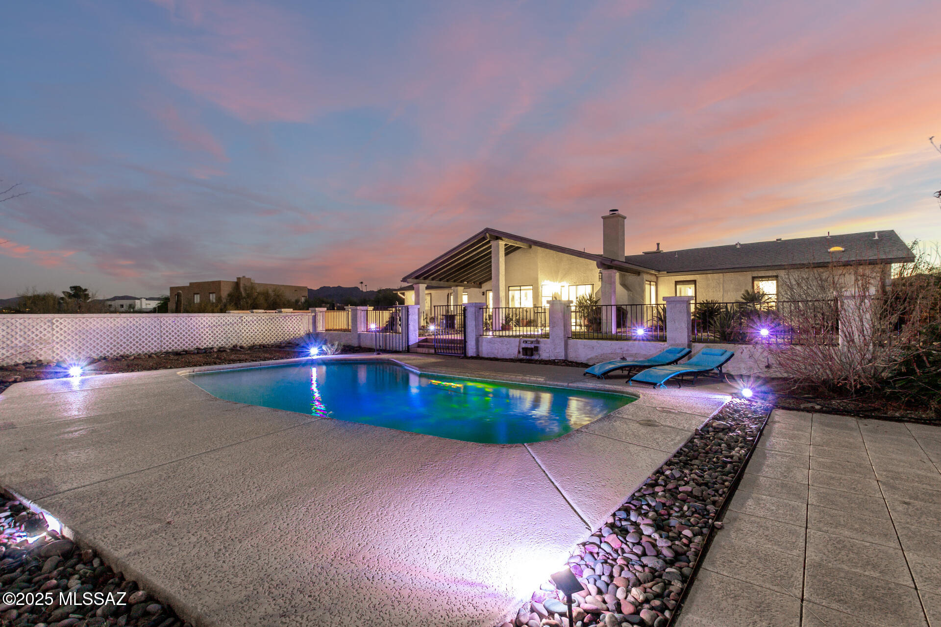 Your dream home is within reach! With incredible hillside views of Tucson, a sparkling pool, impeccable landscaping, and bright open space, this home is comfort both inside and out. High ceilings and perfect flow for entertaining, the indoor living is inviting with neutral shades and space for all. You will love the gourmet kitchen's granite counters, backsplash, wood shaker cabinets, pantry, and built-in appliances, completed with a peninsula for extra prep. The primary bedroom offers an ensuite with double sinks and a practical walk-in closet and gorgeous views. BONUS! You'll also find a well-appointed guest suite with a private entrance, bath, and convenient kitchenette for visitors or use as a rental. This home screams luxury, but with incredible value. Book your visit today! The true highlight is the stunning backyard, where you can enjoy city-light views of downtown Tucson, majestic mountain backdrops, breathtaking sunsets, a covered patio, and a refreshing pool. This gem will sell fast!