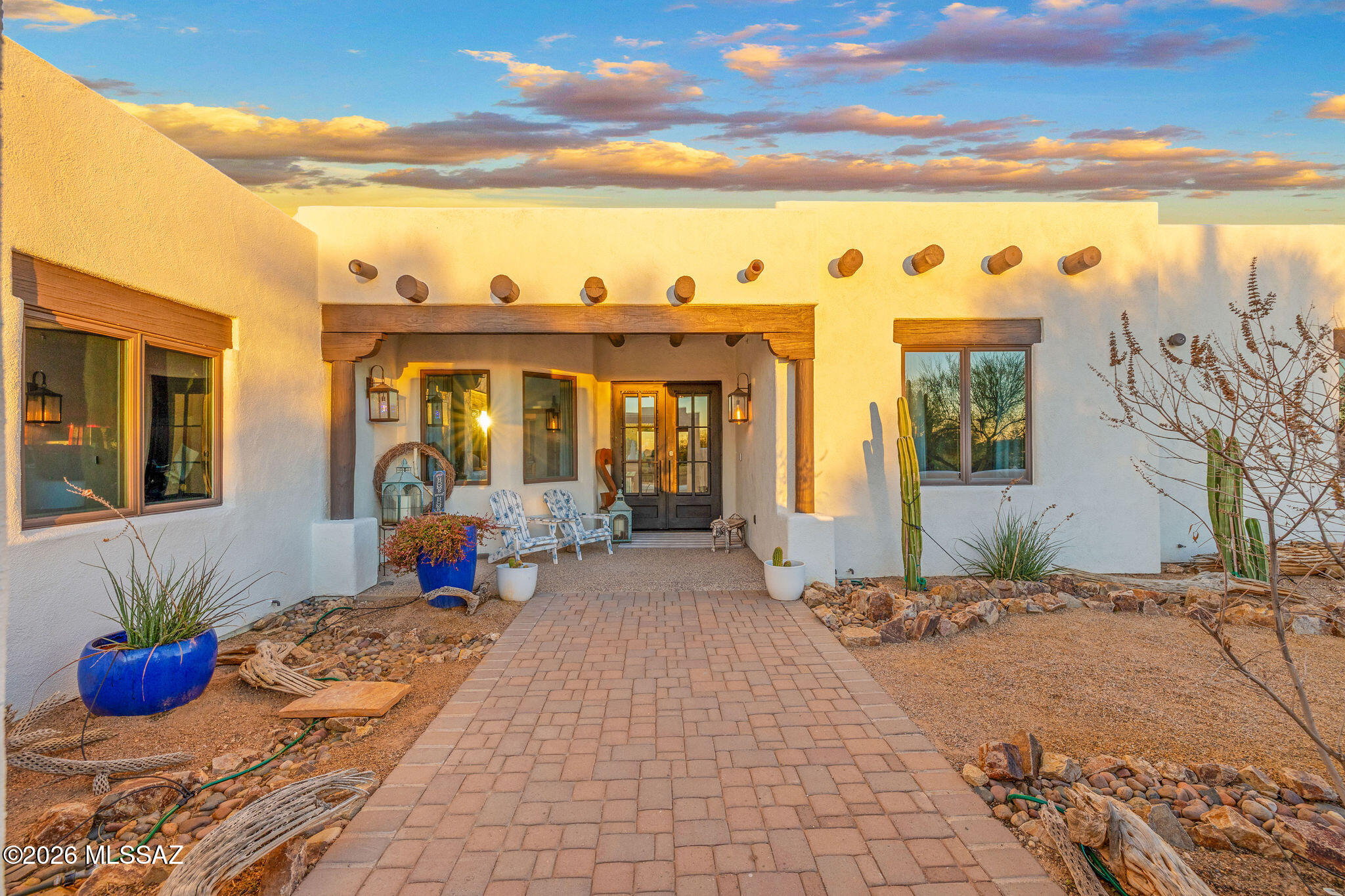 Beautiful custom residence, originally built in 2008 and extensively renovated from 2022-2023, situated on 3.31 acres at the end of a private cul-de-sac enclave of just five custom homes. Framed by sweeping Catalina and Tortolita Mountain views, this no-HOA property with horse privileges offers an exceptional blend of privacy, space, and refined desert living. Encompassing over 4,000 square feet, this single-level home features 5 bedrooms, 3.5 baths, a dedicated office/den, and a generous bonus/recreation room. Architectural character is showcased through vega beams, exposed wood columns, a statement stone fireplace, and Andersen dual-pane windows, while cohesive 2'x4' tile flooring enhances the main living areas. Both the interior and exterior have been recently repainted, with(continued) updated lighting, ceiling fans, and added SolaTubes that bring in abundant natural light. A custom glass-and-metal front entry door opens onto a private courtyard with captivating sunset views, and the driveway is prewired for a future electric gate. Just inside, a glass-enclosed office near the entry creates a polished and functional work-from-home environment. The gourmet kitchen is thoughtfully designed with a wall oven and microwave, 6-burner gas cooktop with griddle, dual-tier workstation island sink, warming drawer, custom cabinetry, and granite countertops with extensive seating area, ideal for both daily living and entertaining. A split-bedroom layout enhances privacy, with a spacious primary suite featuring dual closets, dual vanities, a walk-in shower, and a separate soaking tub. Four additional bedrooms occupy the opposite wing, including an ensuite with direct access to the backyard and pool. At the center of the home, the expansive bonus/recreation room with kitchenette and half bath offers exceptional versatility, currently used as a gym, but equally suited for a home theater, teen lounge, guest quarters, game room, or executive workspace. Additional amenities include a laundry room with extensive cabinetry and a second refrigerator, and an oversized 3-car garage with epoxy flooring and newer insulated garage doors. A circular concrete driveway provides ample parking and ease for guests. The outdoor living environment is truly resort-inspired. A resurfaced PebbleFina pool, approximately 10 feet deep, features a lagoon-style design with spa, swim-up bar, water features, and automated controls. A well-appointed outdoor kitchen anchors the entertainer's backyard, complemented by multiple seating areas, a cozy outdoor fireplace, and mature landscaping with abundant fruit trees and palms. Expansive paver patios and grassy areas complete the setting, all oriented to maximize the stunning Catalina Mountain views. A rare offering, fully renovated, thoughtfully designed, and perfectly positioned to capture the essence of luxury desert living.