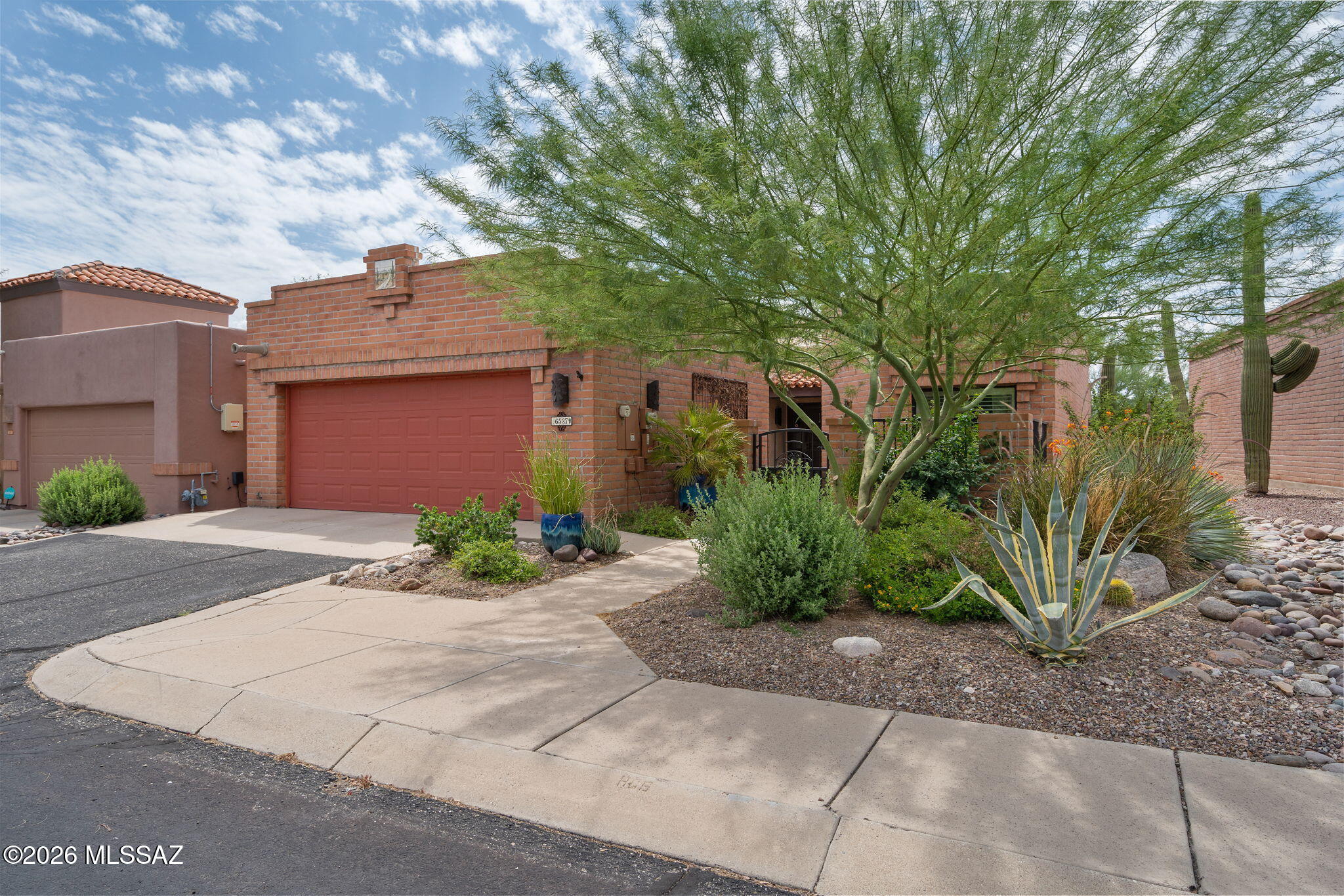 Move-in-ready home in gated Sierra Catalina Estates near La Encantada. Meticulously maintained with a split-bedroom floor plan, updated kitchen with GE Café appliances, center island, granite countertops, and great room with beamed ceilings, flagstone fireplace, clerestory windows w electronic shades, skylights. Spacious primary suite, tiled shower, large vanity with copper sinks, and walk-in closet. Relax in the screened porch while enjoying desert views and amazing sunsets. Major updates include seller-owned solar (2019), Rheem HVAC (2019), roof coating (2023), and replacement windows (2022-2023). Electronic shades, plantation shutters, new courtyard pavers, two-car garage, storage, & outdoor storage. ENTRANCE CHANDLIER DOES NOT CONVEY. SEE DOUCMENTS