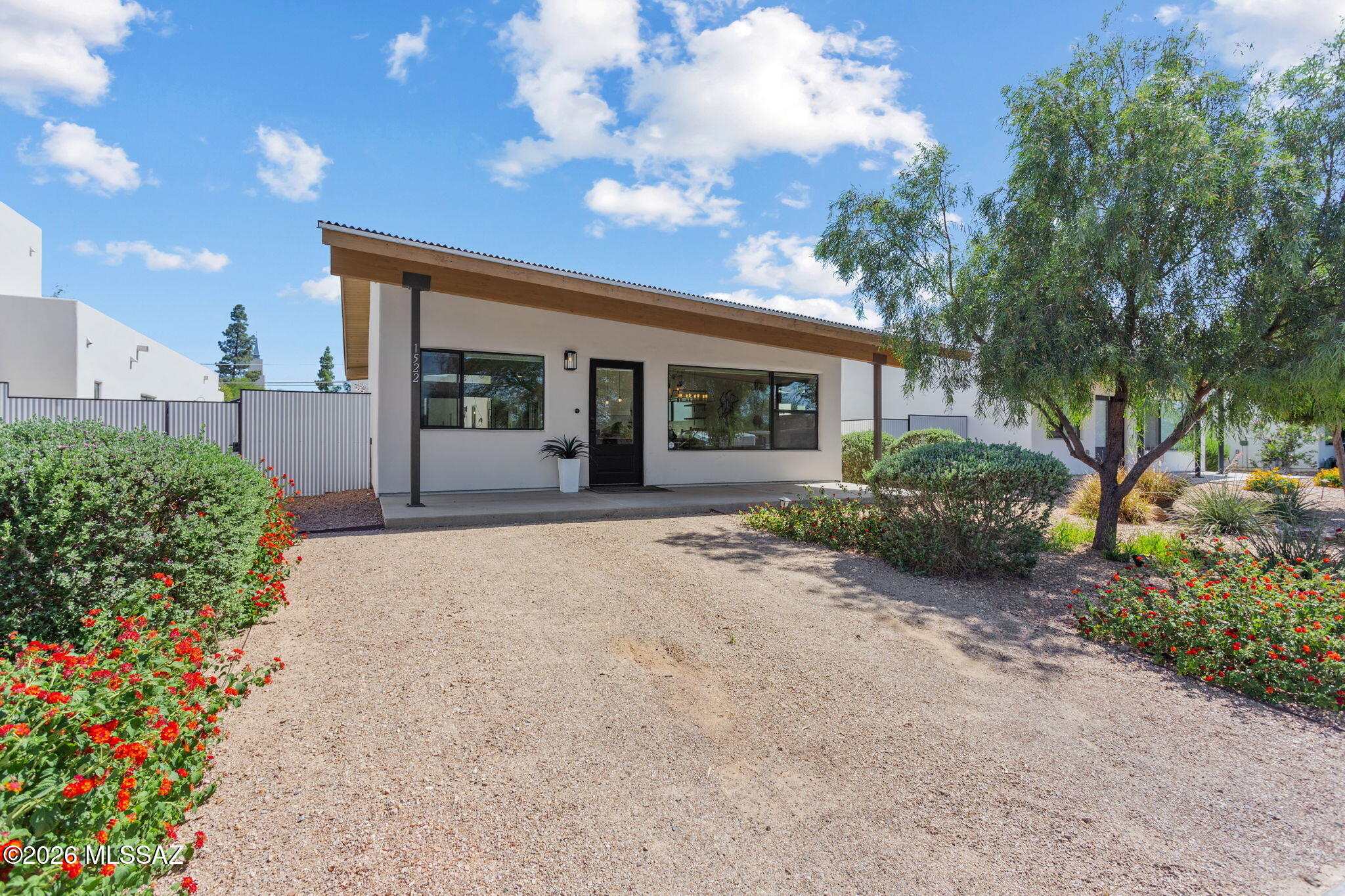 Built in 2022-this contemporary offers the best of modern living in desirable & historic Jefferson Park neighborhood along with access to coveted Blenman Elementary School. Just minutes to UA, Banner & downtown, it provides all the charm of the location, w/the benefits of newer construction, including a coveted 2 car garage. High ceilings, open floor plan & thoughtful finishes, create a bright, light-filled space. The primary offers a soaking tub, separate shower, dual vanities & direct access to a private courtyard patio w/ fire pit & established plantings. The living room also opens to a patio, making indoor-outdoor living effortless & entertaining easy. Whether you're a professional, Wildcat family, or simply someone who wants to be close to everything, this home delivers on all counts!
