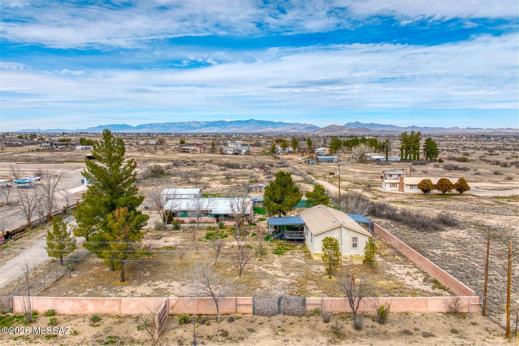 Rare live/work opportunity on 2.95 acres in Willcox! This unique compound includes a 2013 manufactured home (1,104 sf, 3 bed/2 bath, move-in ready) plus a site-built 1,907 sf structure with a metal roof, currently operating as a veterinary clinic. Originally a 4 bed/2 bath home with kitchen, laundry, and fireplace, it can be converted back to a residence or continue as commercial space. The property is cross-fenced and perimeter-fenced, with a large metal carport, multiple storage buildings, kennel runs, and mature fruit trees. Two wells serve the property, one for the home and one for irrigation. Zoned RU-2 for residential and commercial use, this property is ideal for a home business, rental income, or simply extra space and flexibility.