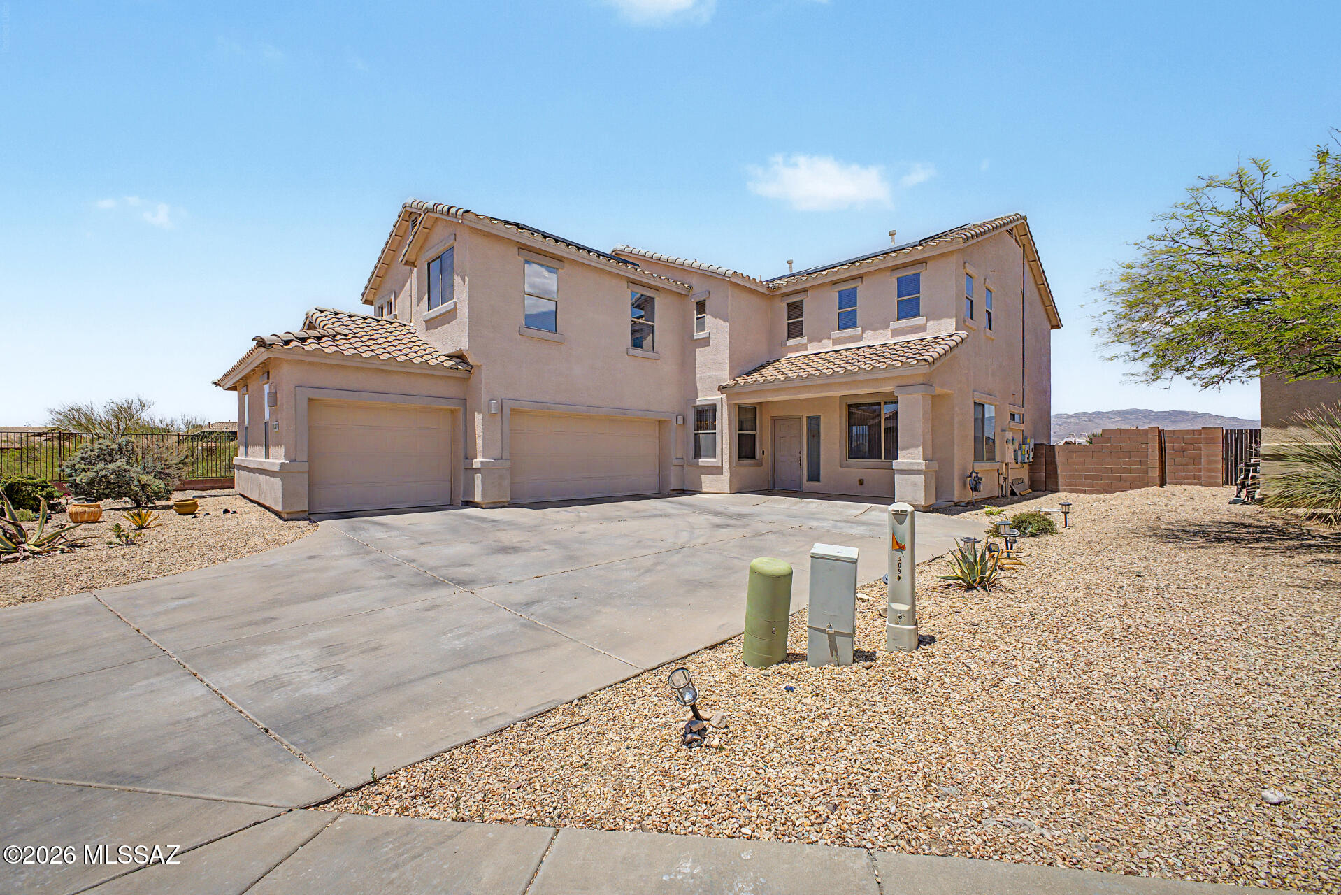 Experience Arizona living at its finest on a premium showcase lot offering exceptional privacy and breathtaking mountain views, stunning sunsets, and sparkling city lights. This popular, spacious floor plan features an open-concept kitchen with granite countertops flowing seamlessly into the family room, perfect for entertaining. A downstairs bedroom and full bath provide flexibility for guests or multigenerational living. Upstairs, you'll find generously sized bedrooms and an oversized primary suite designed for comfort and relaxation. The resort-style backyard is fully landscaped and turnkey, featuring a large pool, putting green, and plenty of space to enjoy the outdoors. Ample storage throughout completes this incredible home.