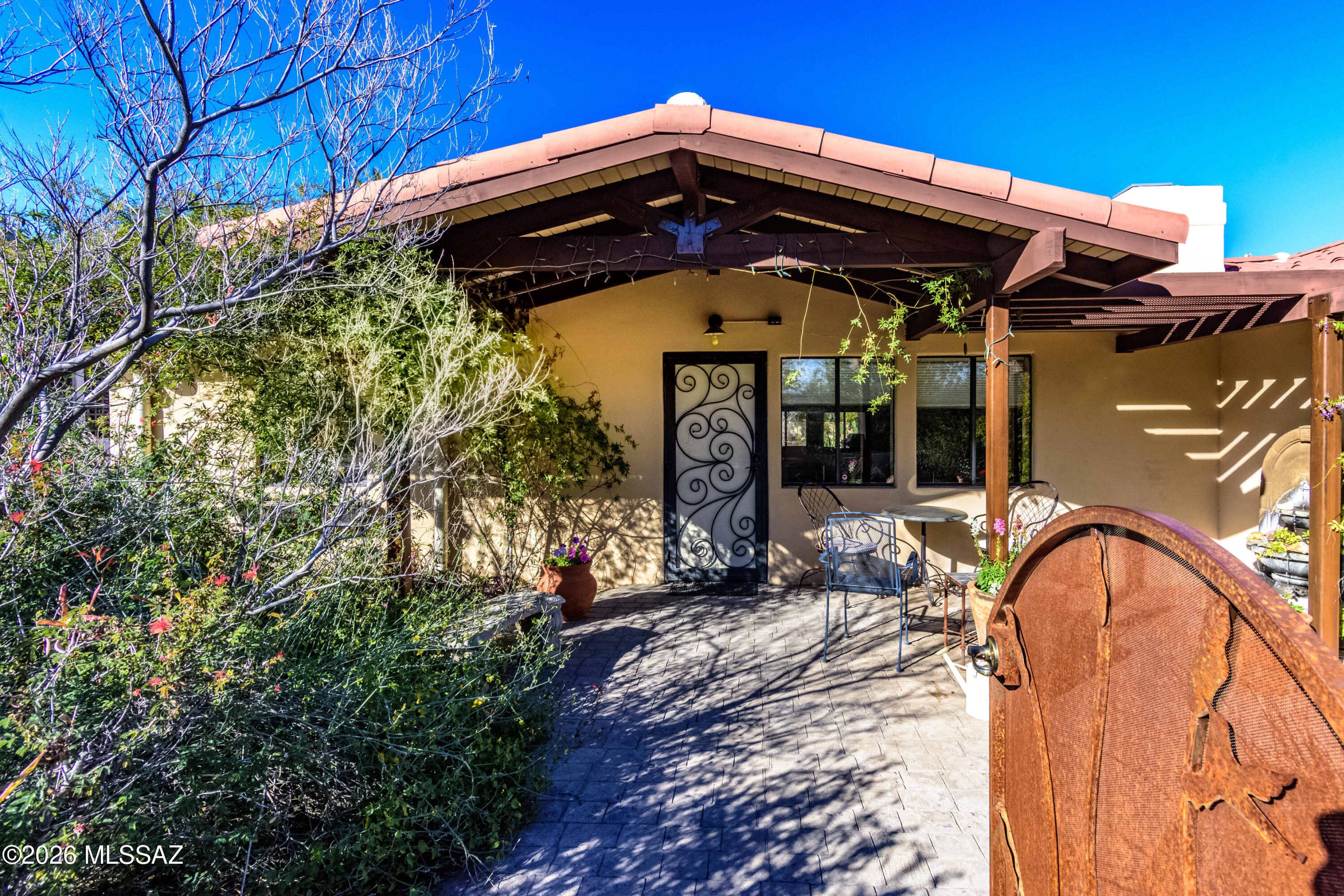 Gorgeous mid-century modern in Historic Catalina Vista neighborhood. 4  bedroom/3 ba with flowing floorplan. Great room w/fireplace & dining, kitchen w/new Corian counters, wine fridge and tons of cabinets. Split 4th bedroom, perfect guest space/office. Tile, polished concrete and cork floors, A/C new 2023, new appliances 2024. New 2 car garage built 2017, climate controlled. Front patio/yard is show-stopper with professionally designed mature native  Xeriscape landscaping, blooming desert plants and trees w/800 gal harvesting tank & irr system. Custom designed security doors and gates Enjoy the birds and butterflies in your own personal sanctuary. Perfect location near Banner Hospital and Univ of Ariz a cycle ride away. Tahoe Park is perfect for dogs and kids.