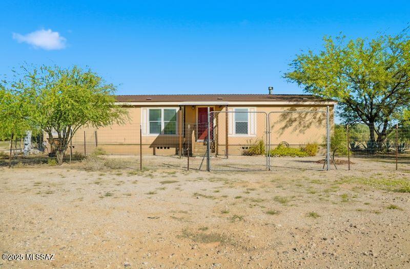 Welcome home! Located in a quiet country neighborhood, this 3 bed 2 bath manufactured home is waiting for you. Here you'll find the perfect blend of comfort and rural charm, all situated on just over 1 acre with a work shop, and an expansive outdoor space with room for gardening, play, animals, or just enjoying the beautiful desert sunsets. This property is ideal for families or anyone looking to get away from the hustle and bustle of the city. Move in ready and priced to sell! Contact me today for your showing.
