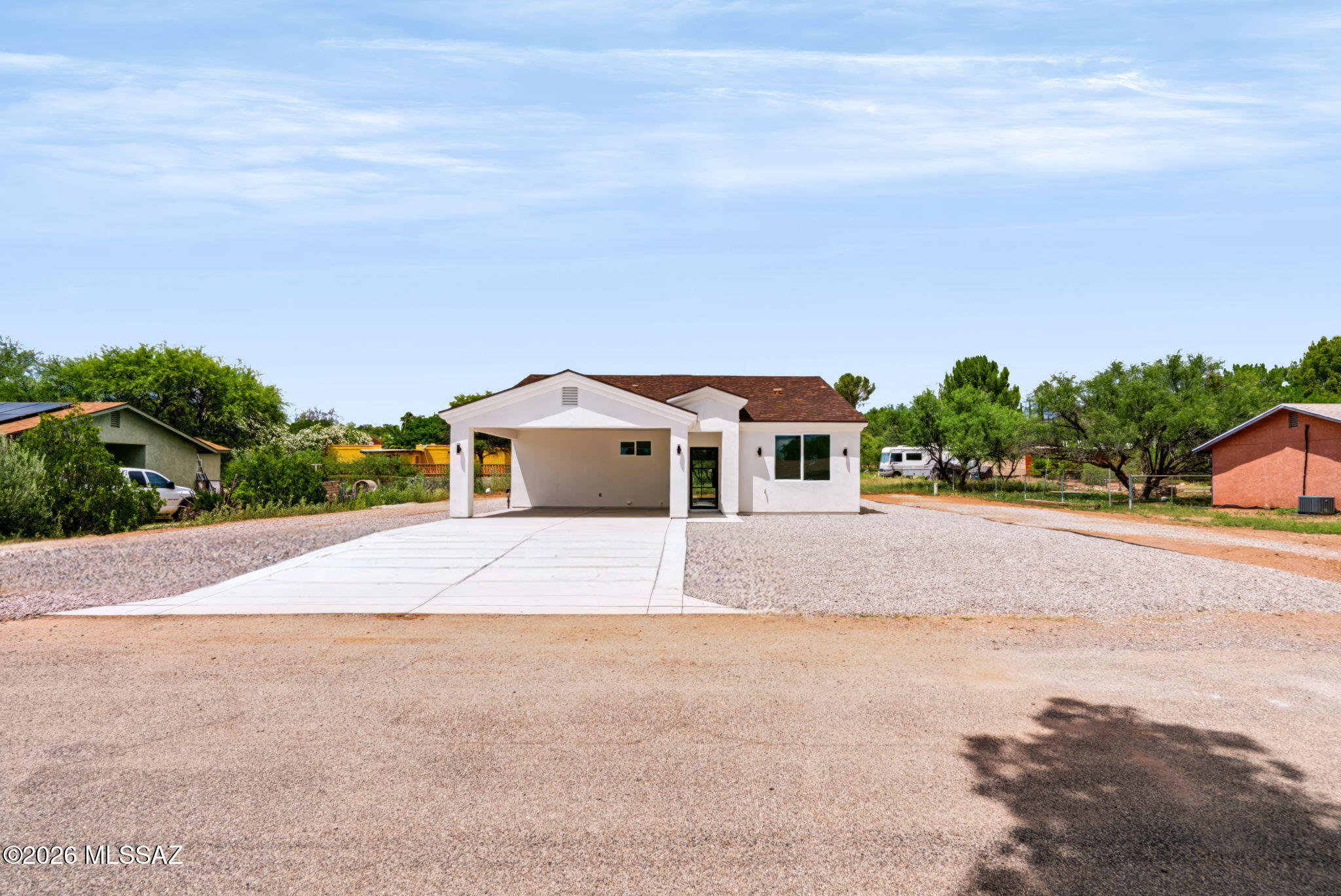 This beautifully crafted modern new construction home offers 1,464 square feet of thoughtfully designed living space. Step inside to an open concept floor plan featuring ceramic tile throughout for a clean look. The custom white kitchen is a true showstopper, complete with stainless steel appliances, black finishes. soft-closing hinges, spacious pantry, stunning quartz countertops, and island all illuminated by modern light fixtures that elevate the space. The primary suite is generously sized, featuring a walk-in closet and a large tiled shower for a spa-like experience. The guest bathroom offers a dual vanity, ideal for family or visitors. Additional highlights include a dedicated laundry room, a covered over extended carport, covered back patio perfect for outdoor entertaining, and a very usable lot ready for your personal touch. Constructed with upgraded stucco and topped with a sleek brown double-layer shingle roof, this home blends style and durability. Located walking distance to Rio Rico fitness center, walking trails, church, San Cayetano Elementary school, and only 6 minutes away from I-19. Don't miss the opportunity to own this move-in ready modern gem!
