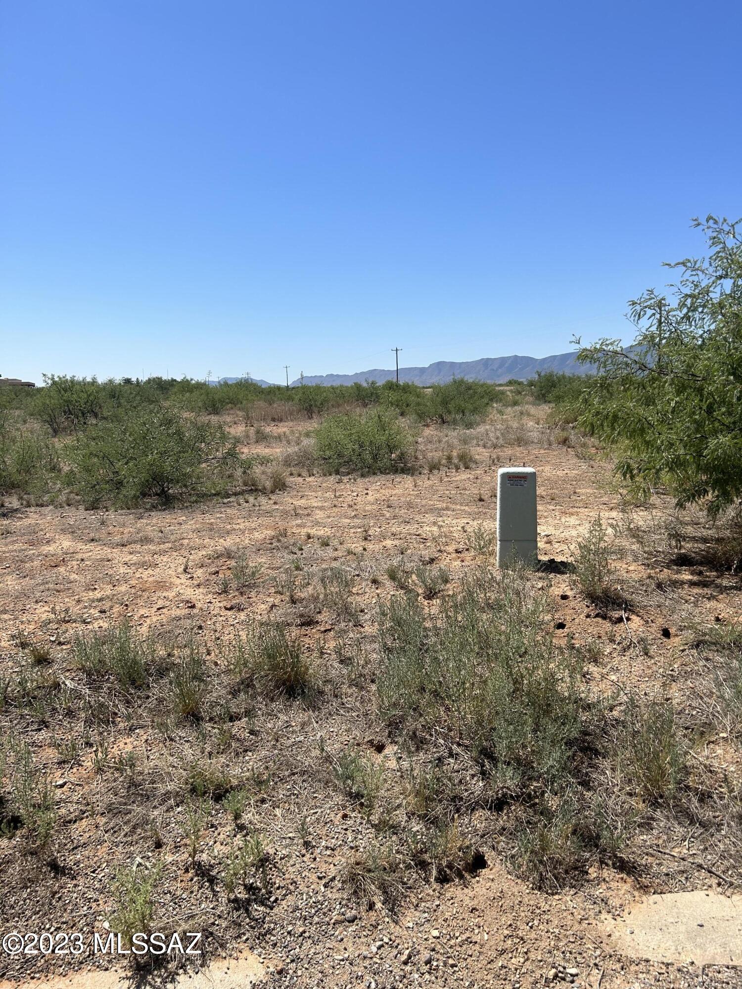 Great flat, buildable lot with easy road access! These three combined parcels offer over 2.5 acres of opportunity, showcasing stunning views in every direction. Take in the expansive Dragoon Mountains and surrounding farmland right from your property. No HOA! Located in a master-planned community with utilities nearby. Build your dream home or bring in a new manufactured home—your choice! Buyer to verify utilities.