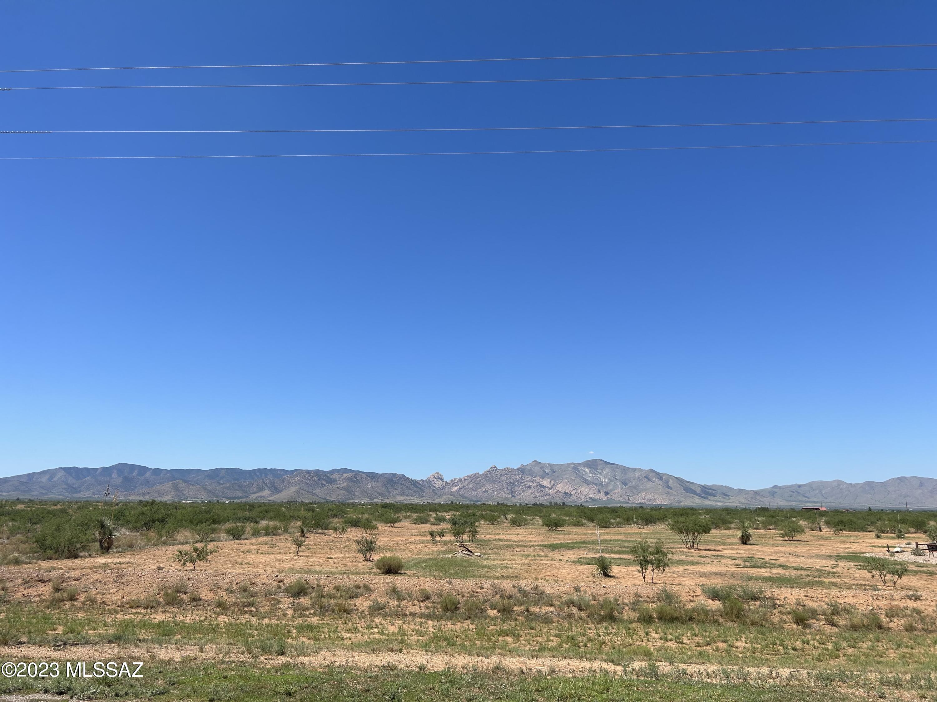 Great flat, buildable lot with easy road access! These three combined parcels offer over 2.5 acres of opportunity, showcasing stunning views in every direction. Take in the expansive Dragoon Mountains and surrounding farmland right from your property. No HOA! Located in a master-planned community with utilities nearby. Build your dream home or bring in a new manufactured home—your choice! Buyer to verify utilities.
