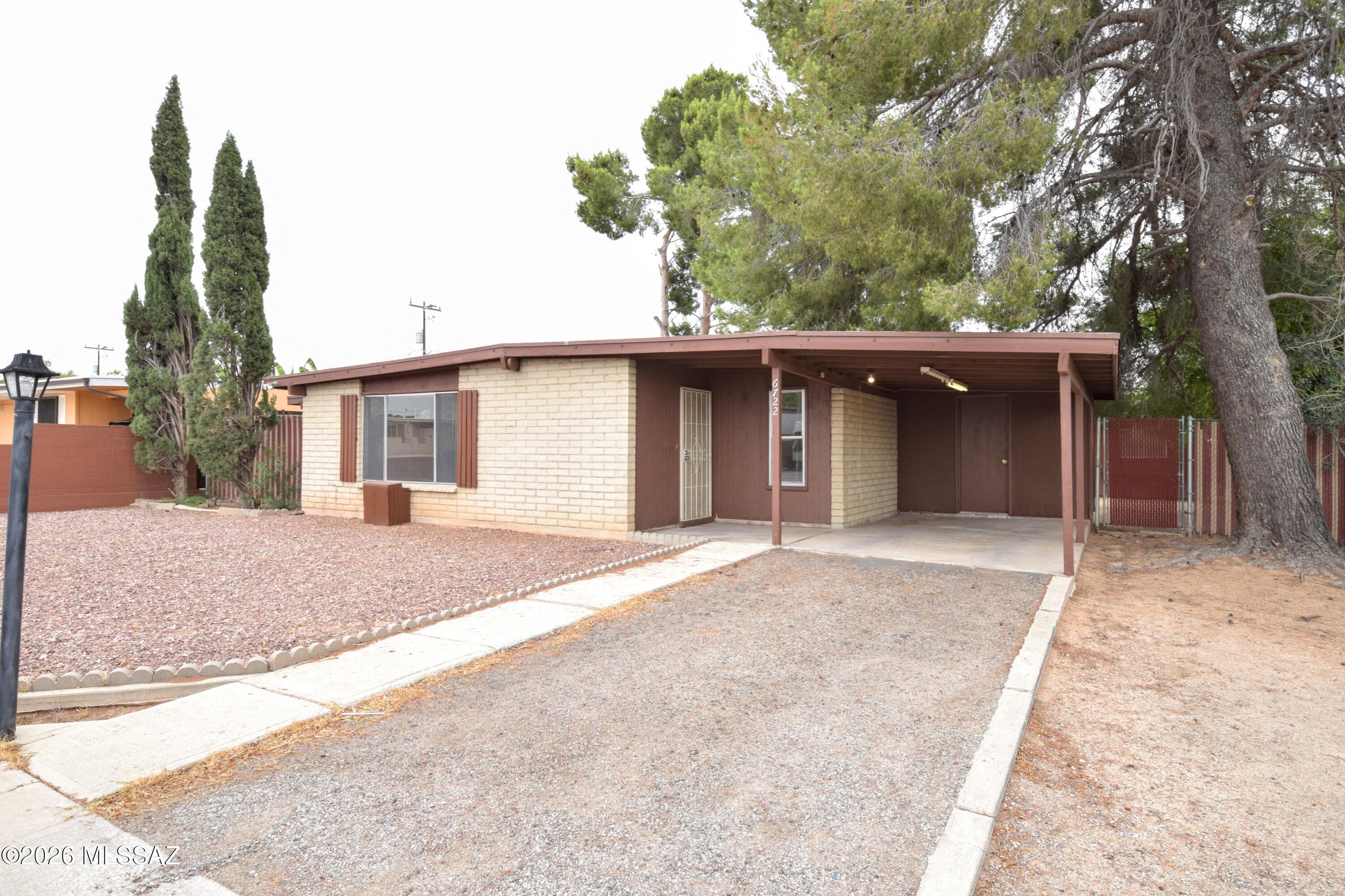 This 1179-square-foot 4 bedroom 2 Bath single-family home offers a perfect blend of modern comfort and functional living. The single-level layout features four bedrooms and two bathrooms, completely refreshed with fresh paint and durable tile flooring throughout the entire home. The bright interior is flooded with lots of natural light and boasts an inviting eat-in kitchen complete with a charming breakfast nook. For year-round indoor comfort, the home is equipped with highly reliable central air conditioning and central heating systems. Step outside to find an expansive, fully fenced backyard that features a private covered patio, perfect for relaxing or entertaining outdoors, alongside an oversized storage unit for your extra gear. Conveniently located in the storage unit are washer and dryer hookups to make laundry day a breeze. The pet policy allows for dogs to be considered on a case-by-case basis, though no cats are permitted on the premises. This home is offered to NON-SMOKING tenants ONLY.