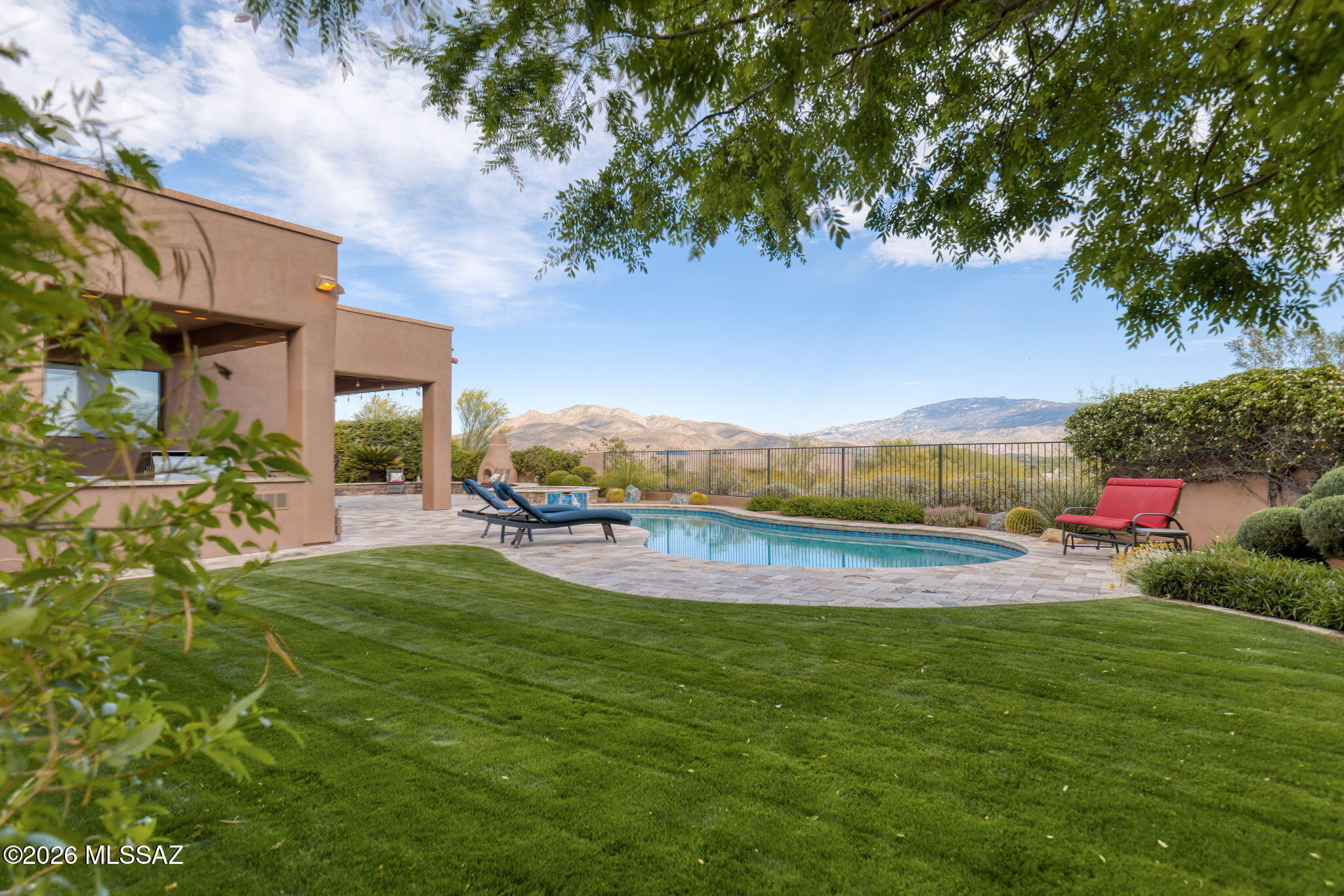 Experience exceptional Tucson living in this stunning 3,696 SF residence with a 395 SF guest casita, set on 1.635 acres in a gated Tanque Verde Valley community. Designed for both refined living and effortless entertaining, the home features a gourmet kitchen, multiple fireplaces, a spacious office off the primary suite, and a 3-car garage. Step outside to a private resort-style retreat surrounded by mature trees and lush plantings, with sweeping mountain views, pool, hot tub, and outdoor kitchen. An exceptional property where every detail invites you to slow down, stay awhile, and enjoy the lifestyle.