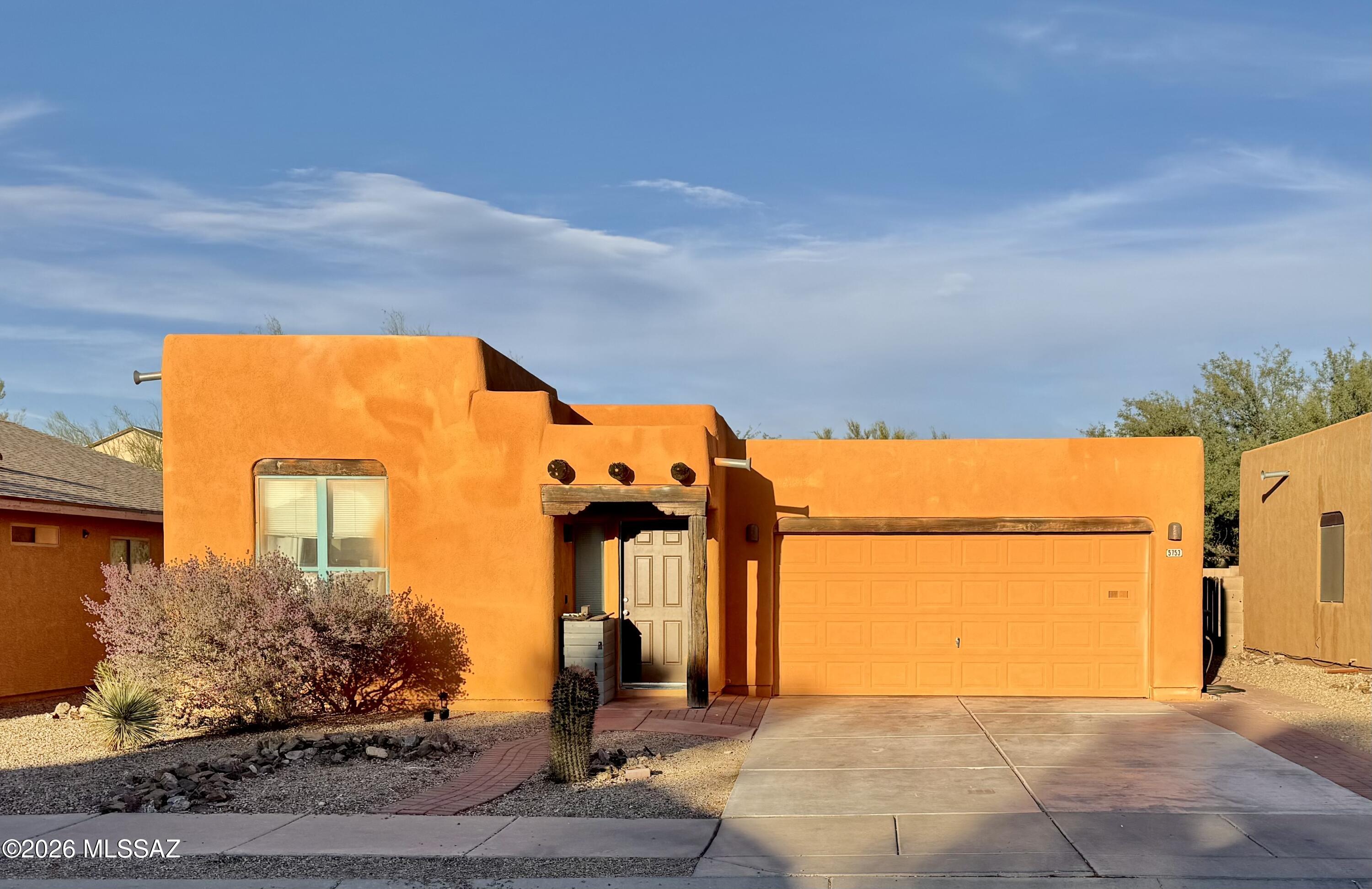 Welcome to 5753 E Vuelta de Nuestro Pueblo, your perfect Santa Fe style home in southeast Tucson. One-bedroom and one-bathroom in a thoughtfully planned layout. The entryway welcomes you into the living area with views of the galley kitchen and large living room with soaring ceilings. Built-in breakfast bar and dining area are perfect for meals and gatherings. The kitchen features modern grey cabinetry, granite countertops, a pantry closet, and a full suite of black appliances that all convey. The hallway leads you into the bathroom with combination shower and tub, a storage closet, and the large bedroom, suitable for a king-sized bed, including a glass panel door with direct access to the rear patio. The backyard is spacious with east-facing views and plenty of shade in the sunny summer evenings. Take cover under the generously-sized covered patio. The two-car garage features high ceilings and built-in cabinetry, including a tandem extension for the washer and dryer. This is the perfect starter home or perfect for someone looking for simple living in a charming neighborhood with easy access to I-10, shopping, dining and more! Welcome Home!