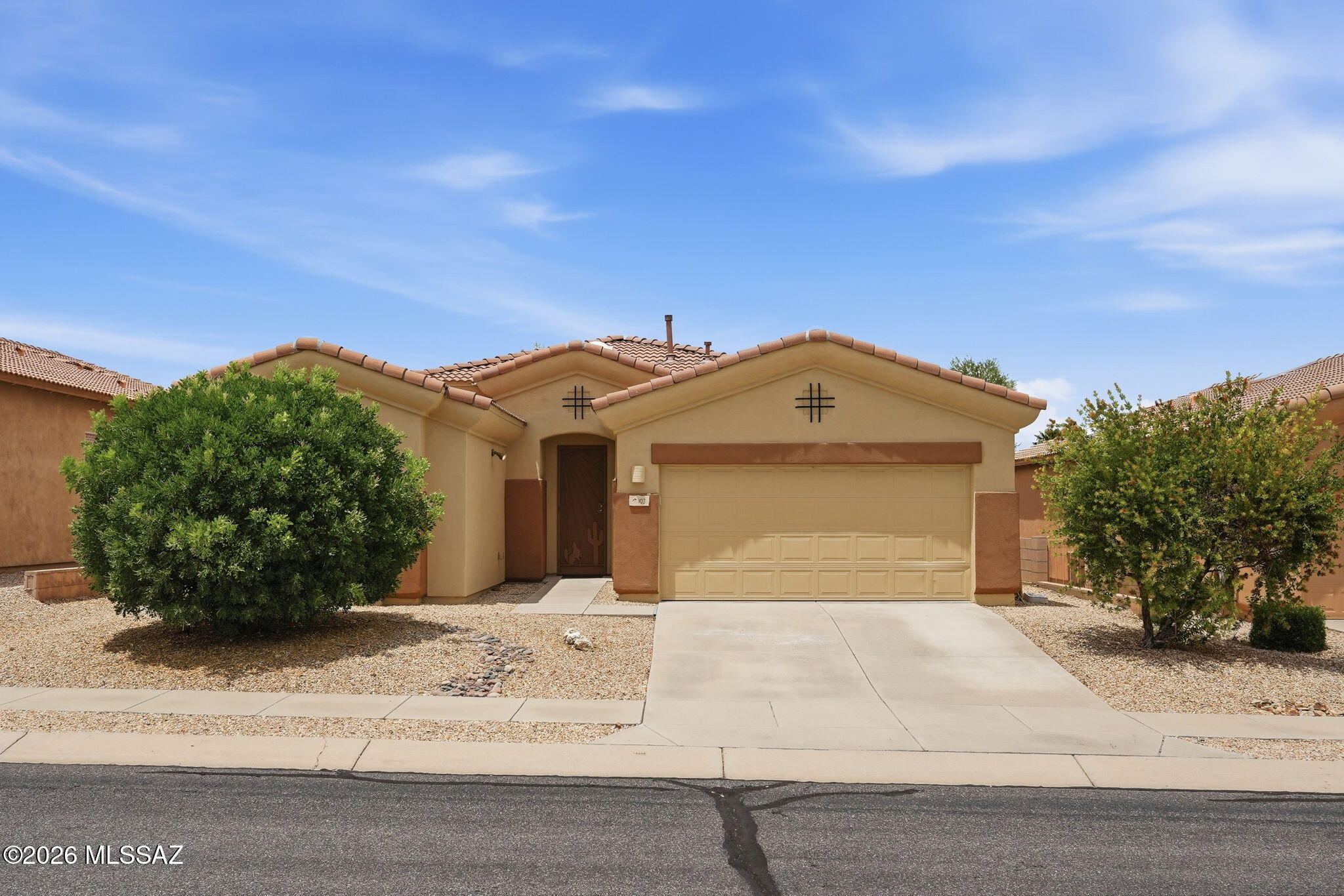 Discover the comfort, quality, and carefree lifestyle you've been searching for in this beautifully maintained Pepper Viner home, ideally located in the desirable 55+ community of La Joya Verde. Enjoy all the benefits of an active adult neighborhood with a community pool, spa, pickleball courts, and a full calendar of social events--all without the expense of GVR dues. Plus, you're just minutes from shopping, restaurants, medical facilities, and everyday conveniences. Step inside to a home designed for easy living. Tile flooring flows throughout the main living areas, while new laminate wood flooring (2019) adds warmth to the bedrooms. The inviting great room is centered around a cozy gas fireplace with custom built-in shelving, creating the perfect place to gather with family and friends. The thoughtfully designed kitchen offers abundant storage with double pantry closets, an elevated dishwasher for added convenience, newer stainless steel appliances (2017), and generous workspace that makes both everyday meals and entertaining a pleasure. Retreat to the spacious primary suite where the sliding glass door has been replaced with a large picture window, bringing in natural light while enhancing privacy. The ensuite bath features dual vanities accented by two distinctive matching framed mirrors, a walk-in shower, and ample storage. Guests will appreciate the hydrotherapy walk-in bathtub with a bidet, providing both comfort and accessibility. Outside, the covered patio spans the entire length of the home and extends onto a beautiful paver patio--an ideal setting for morning coffee, afternoon relaxation, or entertaining under Arizona's spectacular skies. The irrigation system was replaced in 2024, making it easy to maintain the attractive landscaping. Additional upgrades include a new front entry door (2021), new water heater (2025), quality Levolor wood blinds. The two-car garage is set up with washer and dryer hookups for either gas or electric appliances. From its thoughtful updates and quality construction to its welcoming community and convenient location, this exceptional home offers the perfect blend of comfort, low-maintenance living, and the Arizona lifestyle you've been dreaming about. Come see why life is better in La Joya Verde.