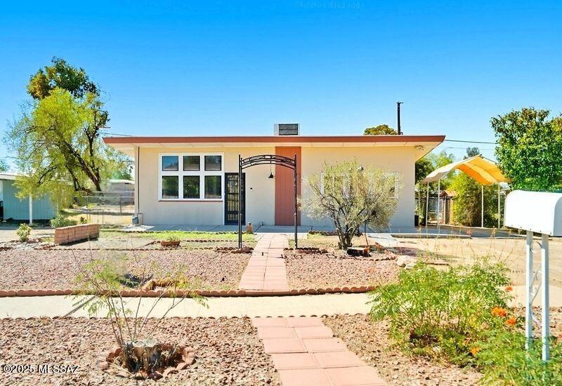 Charming, light, and bright home has been lovingly updated and is move-in ready! This home sits on a spacious lot and features three bedrooms and two full bathrooms. The family room could be converted to an office or fourth bedroom.  The living room, dining area, and open kitchen are perfect for entertaining!  Fresh interior paint, new laminate flooring, new ceiling fans, and new light fixtures.  The roof was recently recoated, and the exterior paint was touched up.  A separate laundry room offers convenience & extra storage. Step outside and enjoy the large covered patio. This home is located close to the UofA Tech Park & the Tucson Marketplace with shops, restaurants! Only 15 minutes from downtown & the UofA.  Agent related to owners.