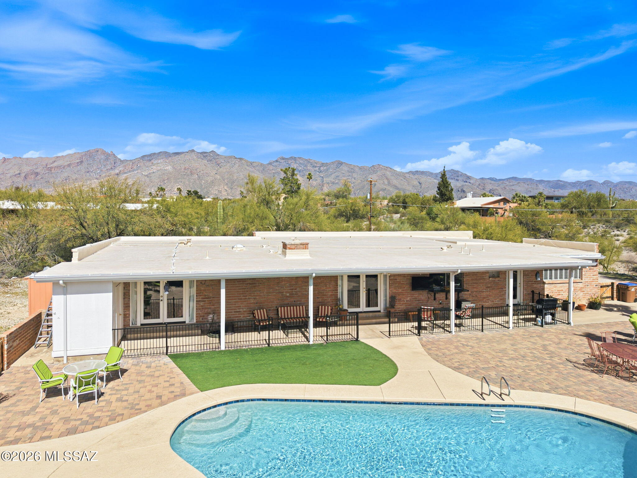 Enjoy elegant foothills living, twinkling city lights and mountain views! A large front covered patio welcomes you into the entry, living room and formal dining area. Comfortable family room with a beehive fireplace and a modern, bright, and open kitchen featuring a breakfast bar and sweeping views of the pool and rear yard. The generous primary bedroom and bath, an additional en suite with patio and pool access, and 2 additional bedrooms all feature ceiling fans. Spectacular outdoor living in a resort sized rear yard and pool area including a full length covered patio! Perfect for family gatherings and special events! Relax in this quiet setting, just minutes from restaurants and shopping!