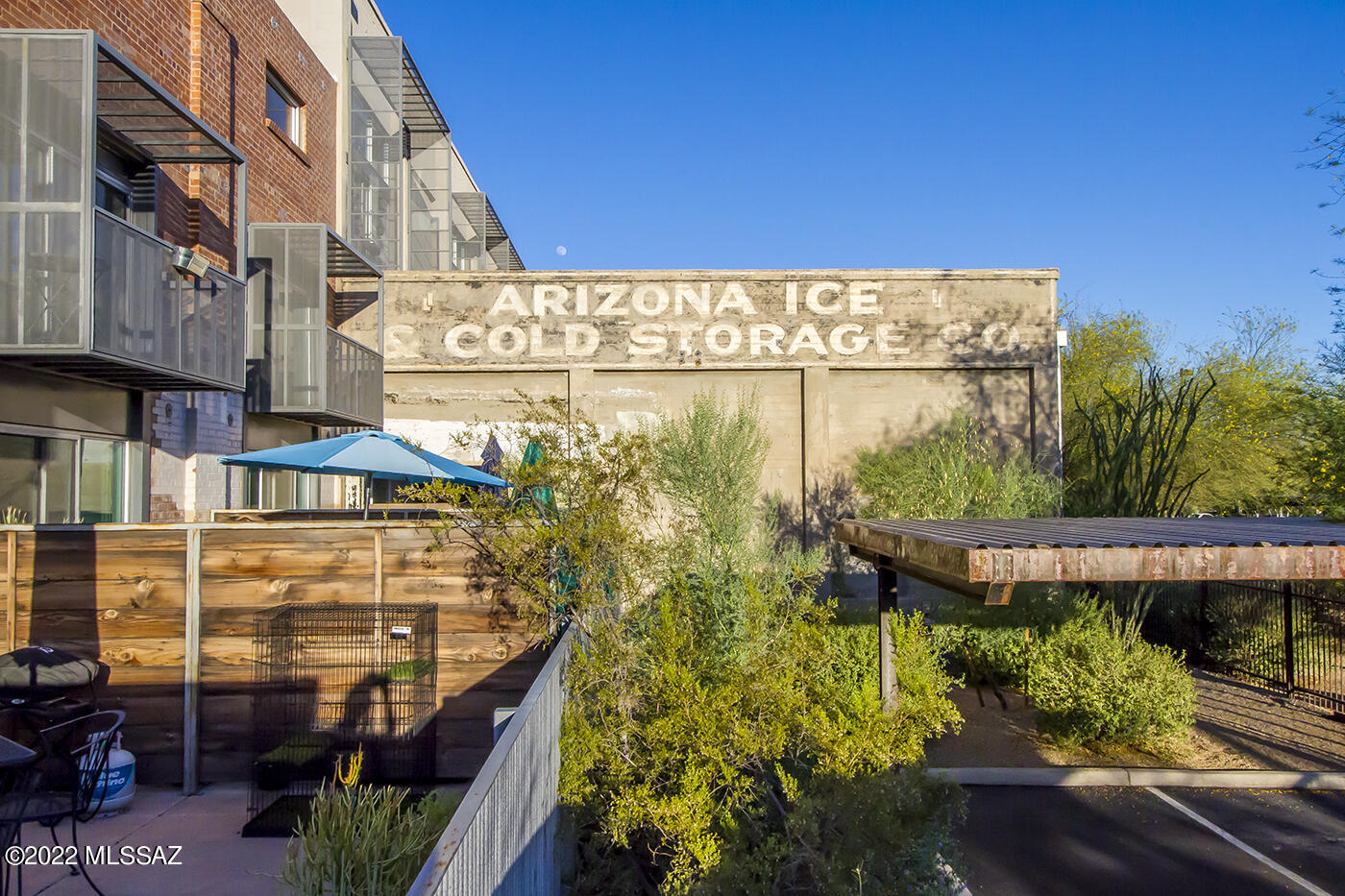 If you're craving walkability, urban energy, and a lock-and-leave lifestyle, pause right here and take a closer look at this studio at Ice House Lofts. Perfectly positioned near the University of Arizona, Downtown Tucson, Five Points, Caterpillar, MSA Annex and Mercado, this is city living at its best.
Step inside and you are immediately struck by the dramatic scale of the space. Soaring ceilings and the architectural crisscross of exposed wood and steel beams create an authentic industrial aesthetic that feels both bold and refined. The expansive layout offers flexibility, the potential to add a separate lofted sleeping or workspace. Rich wood floors ground the space beautifully, while oversized glass doors flood the interior with natural light and open to your private balcony. From there, enjoy sweeping city views with the stunning Santa Catalina Mountains in the distance. It is the kind of backdrop that makes morning coffee and evening wine feel elevated.
The space is enhanced with custom, remote-controlled Hunter Douglas roll-down shades that provides both sound reduction and room darkening. It creates ambiance when you want it and improves energy efficiency year-round by helping regulate heating and cooling.
Industrial character, modern comfort, and an unbeatable location all come together in one unforgettable studio. This is not just a home, it is a lifestyle.
