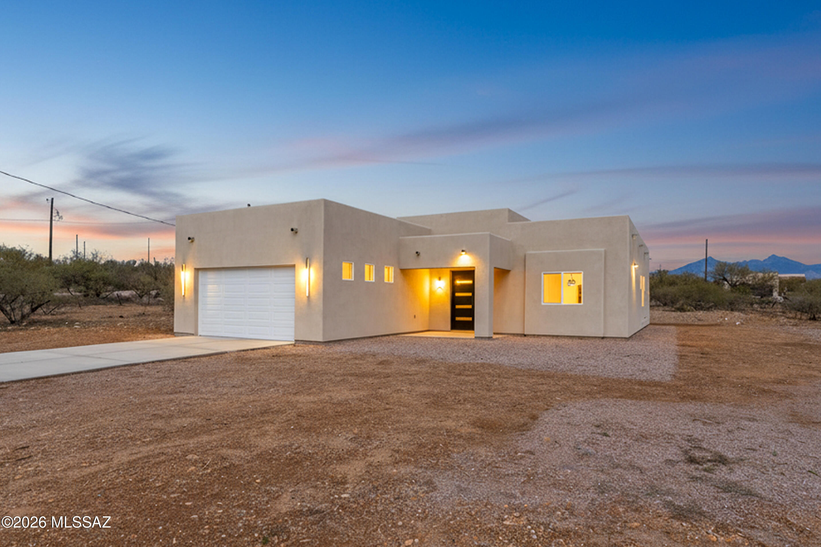 Welcome to this stunning modern new build in Rio Rico, where elegance meets elevated design. This 3-bedroom, 2.5 bath residence features soaring 12-foot ceilings, 8-foot interior doors, a custom statement entrance door that sets the tone the moment you arrive. The open-concept layout is anchored by sleek custom cabinetry, quartz waterfall island, creating a seamless flow ideal for everyday living and, every detail has been thoughtfully curated, from the clean modern lines to the refined finished throughout. Retreat to the luxurious primary suite, a true showpiece with breathtaking aesthetics, generous space and a spa-like ambiance designed for comfort & sophistication. This home is a modern elegance at it's finest, crafted for those who appreciate quality, style, and elevated living.