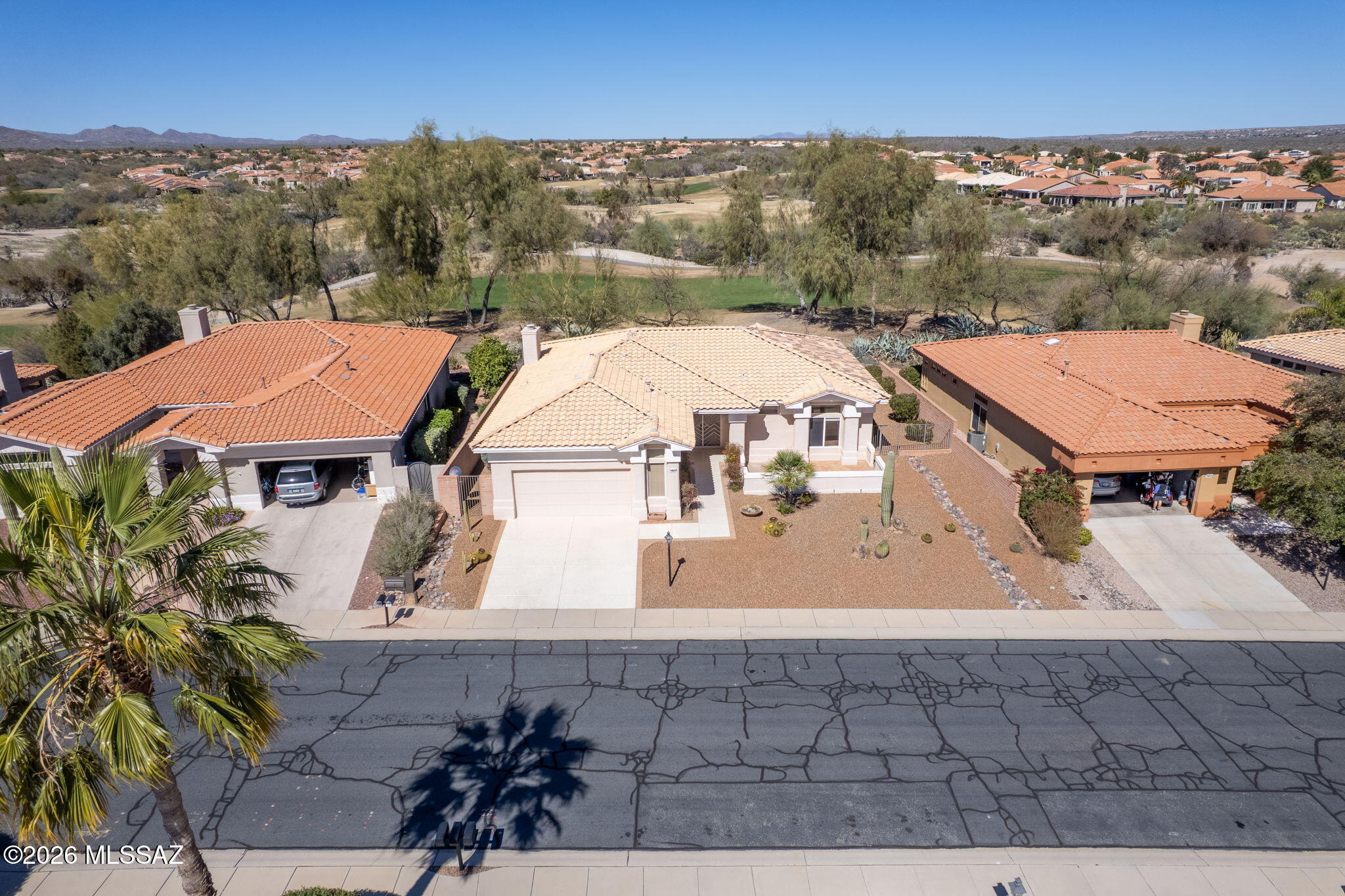 Spectacular expanded Silvercreek model Sun City home (1,839 sqft.). This home sits above the ninth hole of The Views Golf Course & boasts Catalina Mountain Views from the two extended brick paver patios in the backyard. Enter by the walkway leading to the double-doored entryway & courtyard where you can sit & enjoy the views. Featuring 2 bedrooms, 2 full baths, spacious kitchen with electric cooktop, double sink, breakfast bar & dining nook that opens to the family room which boasts a gas fireplace. The spacious main primary bedroom features dual vanities, soaking tub, walk-in shower & large walk-in closet. Sun City is an Active Adult Community close to the championship golf course, state-of-the-art fitness center, tennis courts, 6-lane pool & artisan center. This home is a must see.