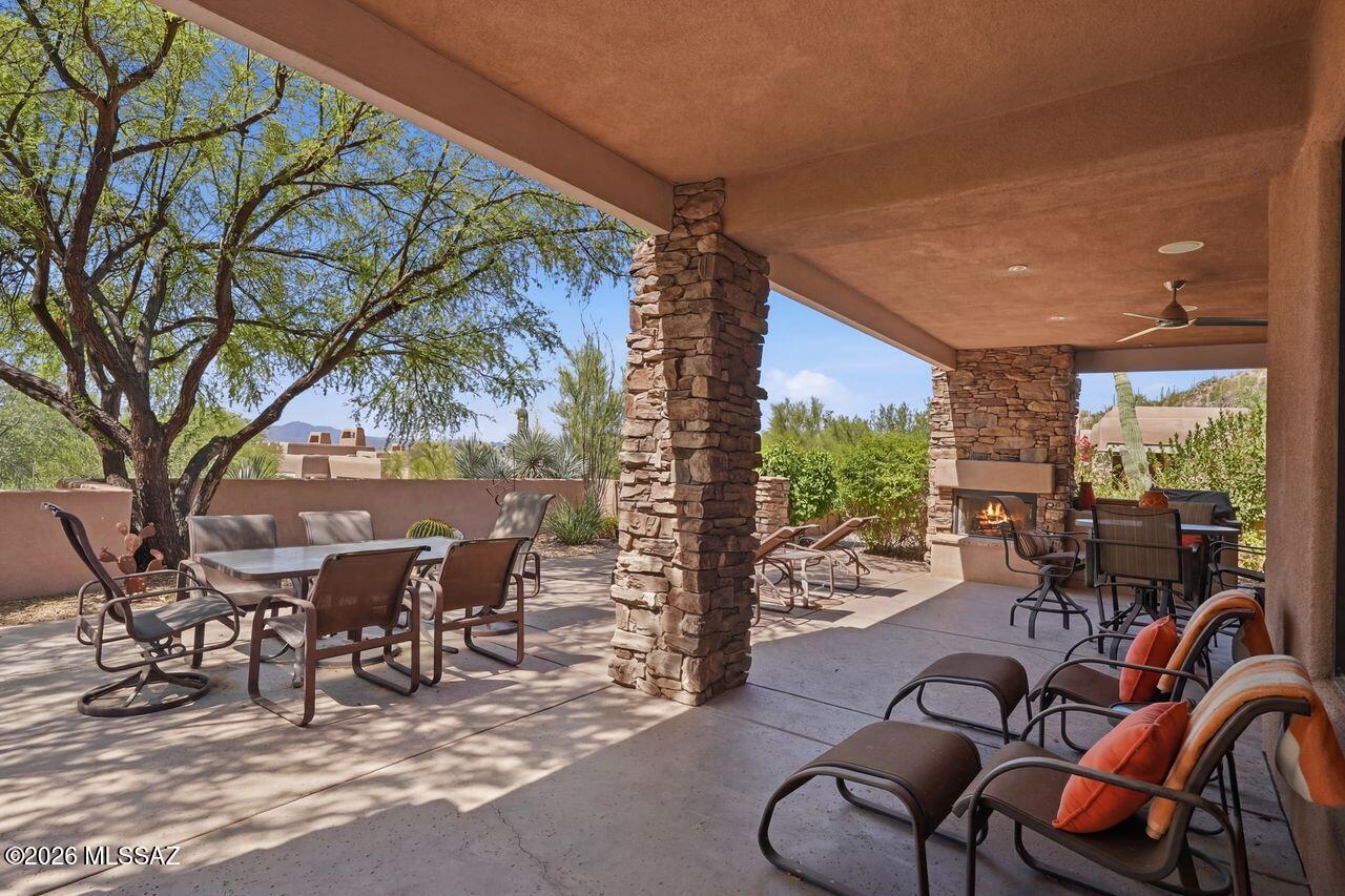 Luxury End-Unit Cottage in the Gated Gallery at Dove Mountain! This beautifully appointed residence offers exceptional privacy & timeless finishes. The kitchen offers maple cabinetry w/ pull-out shelves, granite counters, GE Profile appl, double ovens, breakfast bar, built-in desk & dining nook. The spacious great room is designed for entertaining w/ a stacked-stone FRPL, wet bar w/ wine refer & dramatic wood-beam ceiling. Retreat to the luxurious primary suite complete w/built-in cabinetry, FRPL, organized closets, dual sinks, oversized shower & travertine flooring. The 2nd BDRM incl an adjoining travertine shower, while the 3RD BDRM offers a flex space & shares a private view patio w/ the 2nd BDRM. expansive covered entertainment patio featuring a FRPL, built-in BBQ. New mechanicals!