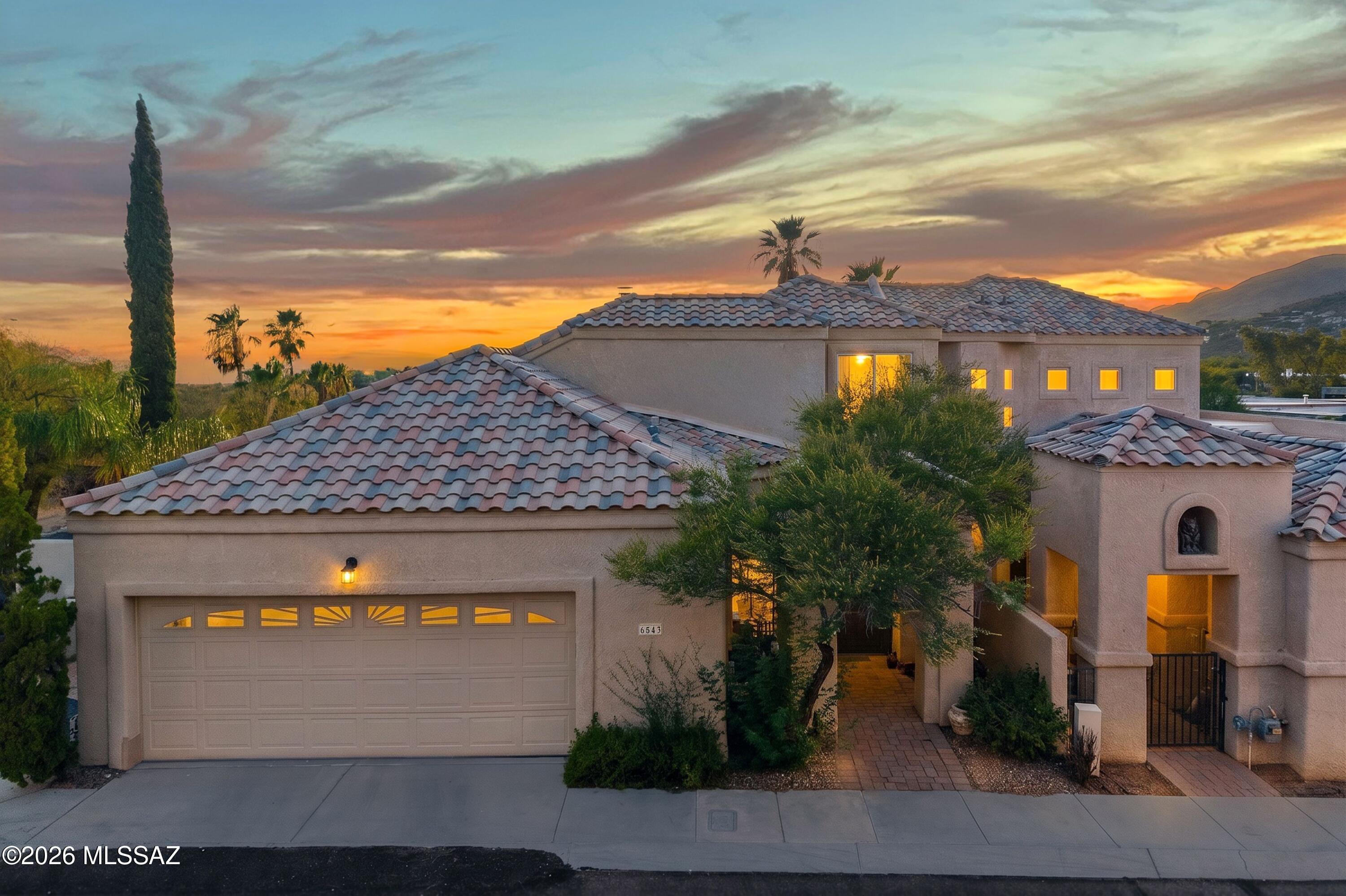 Situated within the conveniently located, guard-gated community of Skyline Country Club, this freshly painted, move-in-ready end-unit townhome offers an exceptional blend of privacy, convenience, and breathtaking views. Enter through an arched entry private courtyard and discover a natural light-filled interior space with vaulted ceilings, travertine floors, and a dramatic gas fireplace.
The thoughtfully designed floor plan features a spacious, great room that flows seamlessly into the kitchen, with granite countertops, custom tile backsplash, stainless steel appliances, gas cooktop, breakfast bar, and a breakfast nook. The main-level owner's suite provides a peaceful retreat with a custom tile shower, soaking tub, a dual-sink vanity, and two generous closets...Continued.. A dry bar, powder room, and direct access to the patio on the main floor complement ease of entertaining.
Rare for the community, the wraparound yard, patio, and pergola extend the living area outdoors, offering multiple spaces to relax and enjoy the indoor/outdoor lifestyle in Arizona. Upstairs, two additional bedrooms and a full bath provide comfortable accommodations for family and guests. One bedroom opens to a private covered balcony where city lights and Tucson's iconic sunset views take center stage.
Positioned to capture both up-close mountain views and elevated city views, Skyline Country Club offers a vantage point unlike any other in the Tucson Foothills. Residents enjoy convenient access to great restaurants, nearby grocery stores, La Encantada mall, the University of Arizona, and downtown Tucson.
Optional golf and social memberships at Skyline Country Club provide access to championship golf, tennis and pickleball courts, an Olympic-sized swimming pool, fitness facilities, dining, and social events--all set against some of the most spectacular views in Southern Arizona. Located within highly-rated District 16 schools.