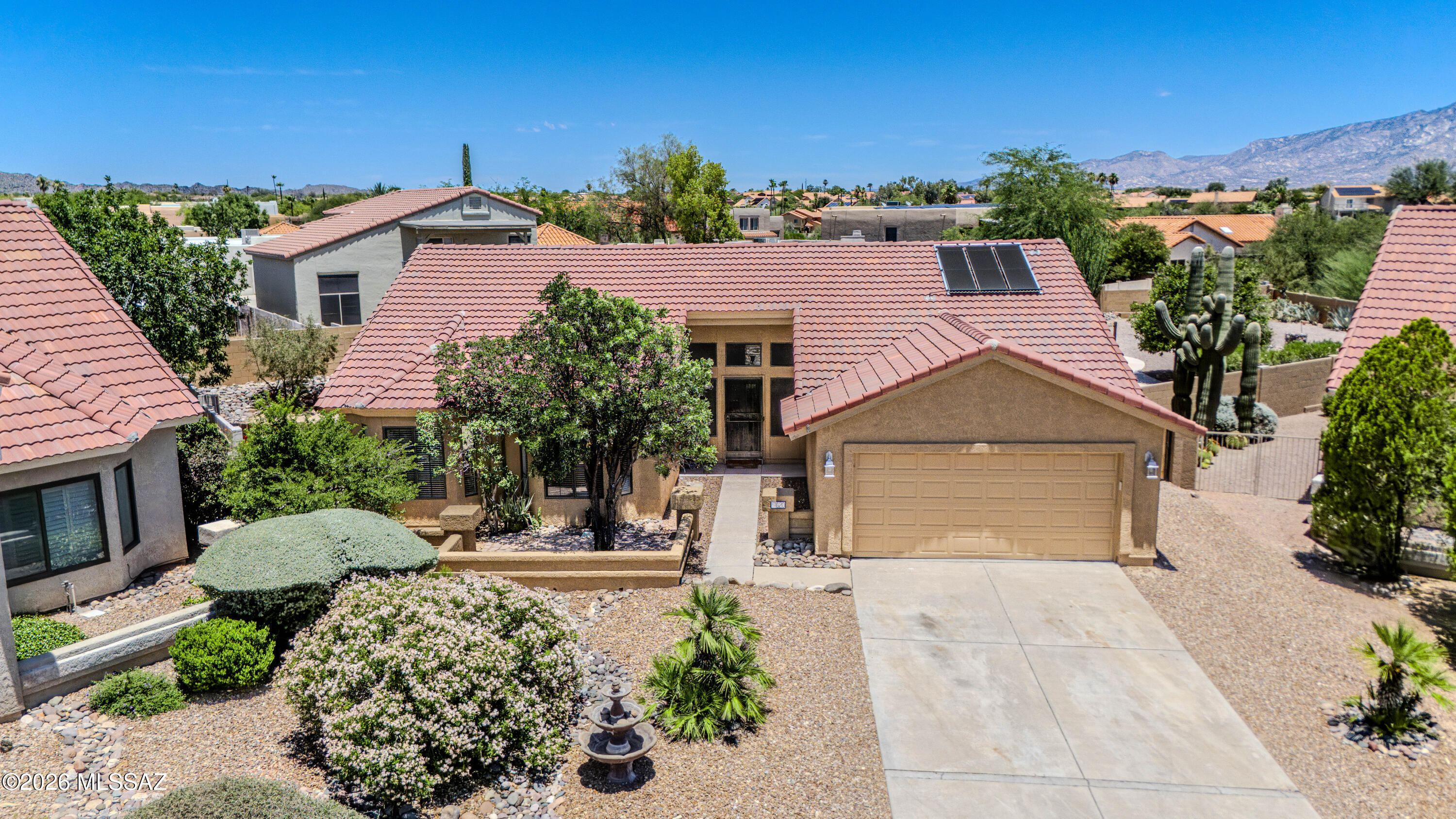 Nestled in the highly desirable Copper Creek community, this beautifully maintained 3-bedroom, 2.5-bath home offers 1,806 square feet of comfortable living space on an oversized 0.34-acre lot. Built in 1988, the home features soaring vaulted ceilings, an inviting fireplace, and an open, light-filled floor plan designed for both everyday living and entertaining. The spacious backyard is a true Arizona retreat, complete with a solar-heated pool, expansive screened patio, and breathtaking Pusch Ridge mountain views. Conveniently located near top-rated schools, parks, shopping, and dining, this home combines privacy, outdoor enjoyment, and a sought-after Oro Valley lifestyle.