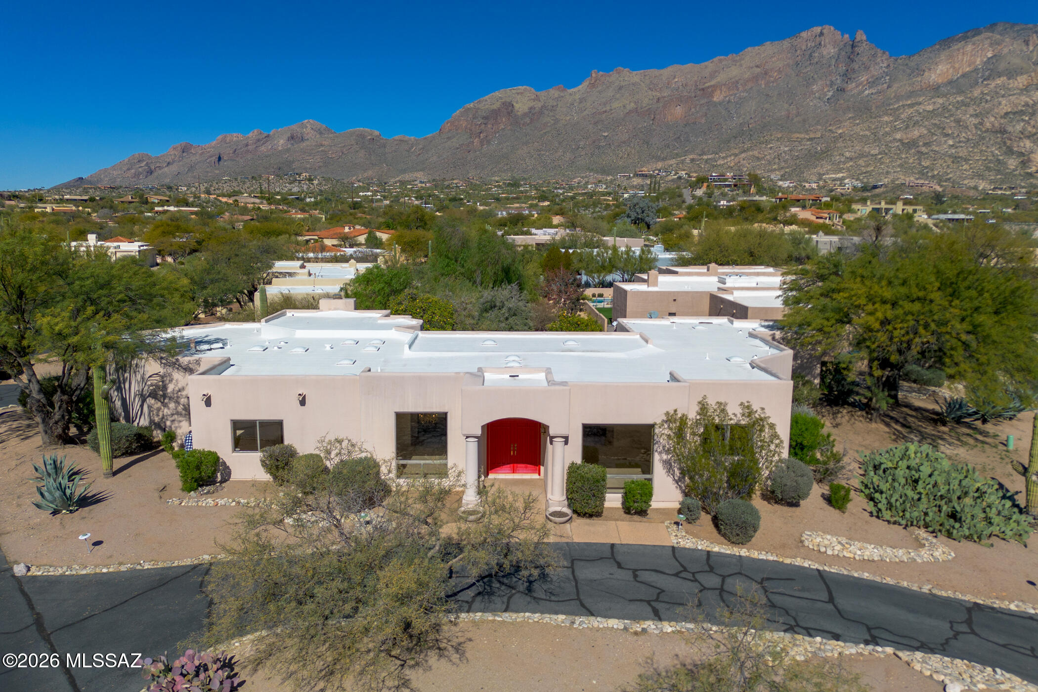 Located behind the guard gated enclave of La Paloma Estates, this custom Wilmeng Homes built 3054 sf home features 3BR/3BA + two bonus/den areas. Upon entry to the home, you are greeted with exquisite views of the Catalina Mountains from a wall of large sliding windows. A large family room with breakfast nook, fireplace and wet bar sits directly next to the kitchen which contains a gas cooktop, Sub Zero refrigerator and loads of storage. The central window in front of the sink is focused on the spectacular mountain view. Additional space for entertaining continues with the formal dining room and living room just off of the main entry foyer. A generously sized, deliberately private Primary Suite features a bonus area which would make a great workout space, den or office. Additionally, the Primary Bath has a walk-in shower, dual sinks, a jacuzzi tub and large, walk-in closet.  Two guest bedrooms (one with bonus area) and two guest bathrooms complete the living space. A substantial 2 car garage with two storage areas gives the additional space needed. The north facing back patio is focused directly on the mountain view, with a beautiful central fountain, grass area and spa for unwinding at the end of the day. While this home requires some TLC and work in certain areas, it is ready for someone to bring in their contractor/designer and make it their own.
Situated within one of the Foothills most prestigious golf communities, this property is mere minutes from incredible shopping at La Encantada, as well as fantastic restaurants that give numerous dining options.