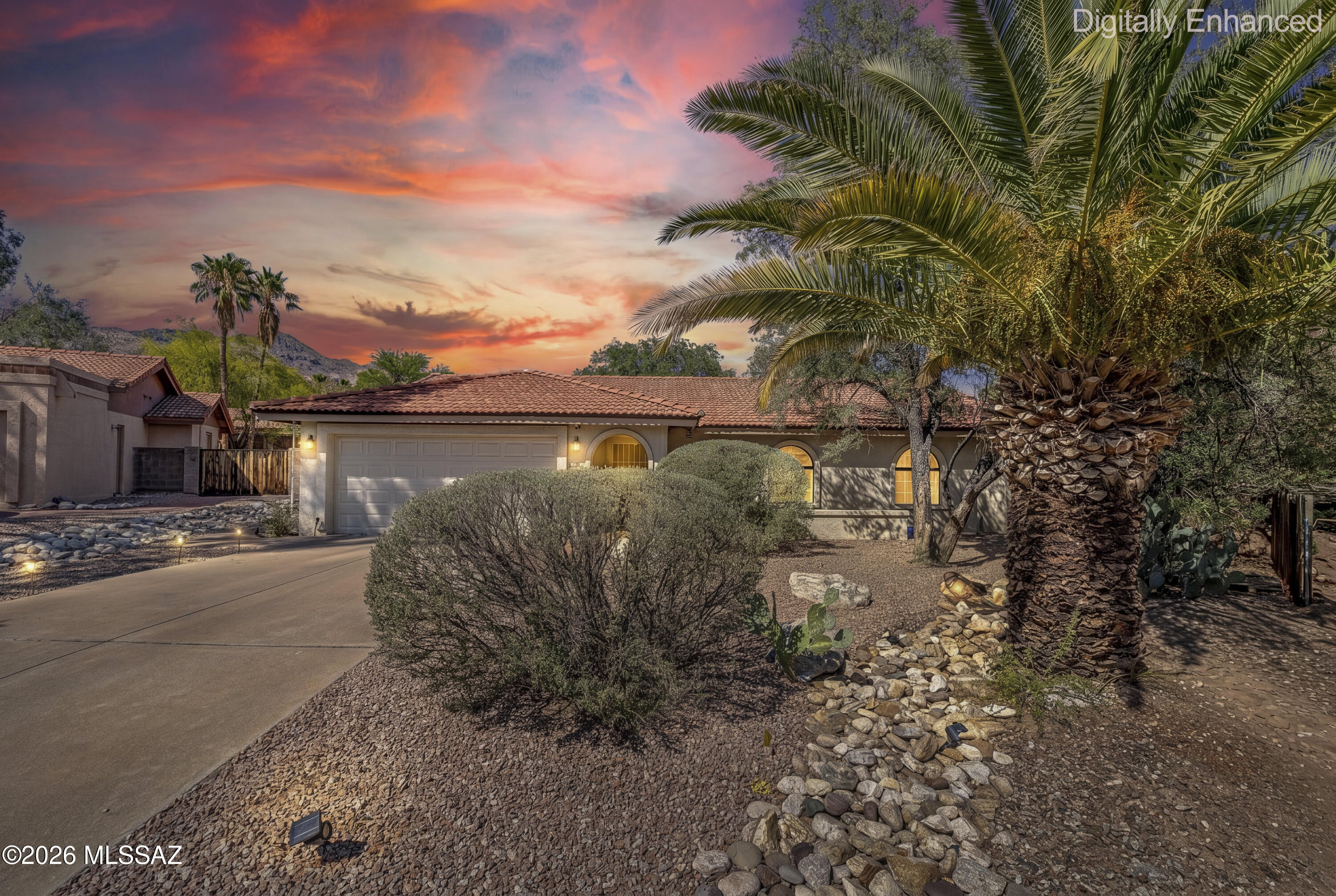Truly a special home. Bright, airy and very welcoming. This home was very thoughtfully and tastefully remodeled with hues of white and blue.  Open floorplan that flows well from living room to dining room to kitchen. Split floorplan.  Decorative tile in bathrooms, beautiful laminate flooring throughout. Wood burning fireplace in dining. French doors from the dining room that open up to a covered patio and a huge backyard!  Room for a pool! Close to Sabino Canyon, great schools, great restaurants and so much more!  You HAVE to see this home today!