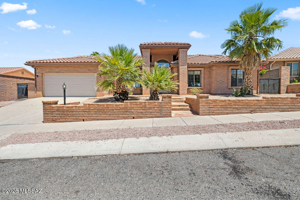 Space, style and mountain views all come together here. This 3-bedroom contemporary home was redesigned with everyday living in mind, opening up the floor plan to create a spacious great room that flows right into a beautifully remodeled kitchen with a huge island, upgraded appliances and tons of storage. Notice the beautiful Mexican Noche Travertine with custom inlay medallions throughout the main living spaces. An additional room off the primary suite offers flexibility for an office, gym or retreat. Outside, The backyard oasis includes a pool, artificial turf and shaded outdoor living spaces with views of the Catalina and Rincon Mountains. Located on a .21-acre lot with no HOA, this Tucson home delivers flexibility, comfort and lifestyle.