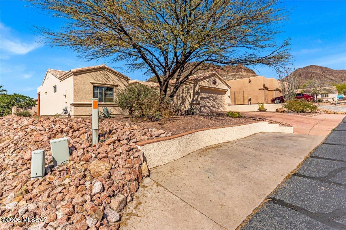 Enjoy comfortable living and beautiful mountain views in this inviting home with an open floor plan and thoughtful features throughout. Decorative shelving creates a stylish separation between the dining and living areas while maintaining a bright, connected space. The guest room includes a convenient Murphy bed, offering flexibility for guests or hobbies, and a bonus room makes a perfect office or den. The primary suite features walk-in closets and a spacious walk-in shower. Step outside to a covered patio with retractable privacy screens and take in the mountain views from the backyard. Community amenities include a pool, spa, pickleball, and tennis courts, plus nearby hiking trails for outdoor enjoyment.