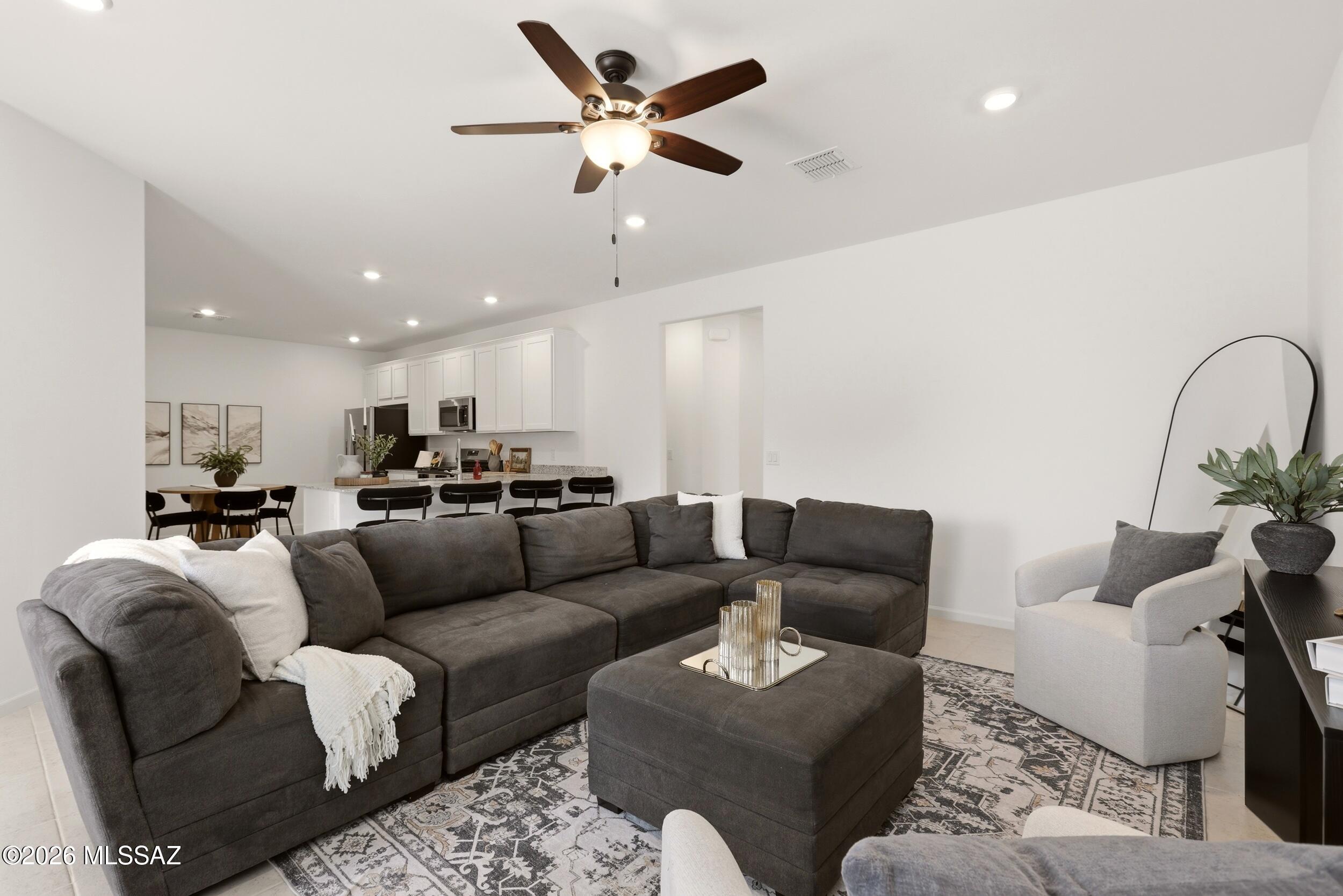 Discover modern living in this beautifully designed home located in the sought after Gladden Farms community of Marana. 
This 3 bedroom, 2 bathroom home features a desirable split bedroom floor plan that offers both privacy and functionality. 
The open concept layout creates a bright and inviting living space, seamlessly connecting the living room, dining area, and modern kitchen - perfect for everyday living and entertaining. 
Enjoy the benefits of owning a nearly new home without the wait for new construction. 
Located in one of Marana's premier master planned communities, residents enjoy miles of walking trails, neighborhood parks, and a community splash pad, with convenient access to shopping, dining and just one block away from the new Tangerine K-8 school!