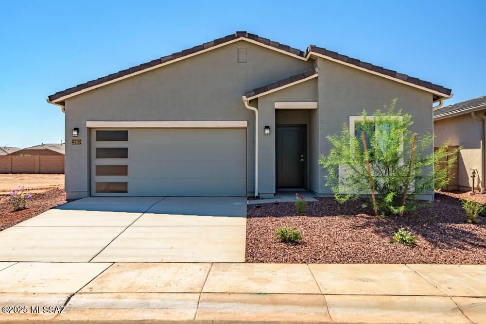 The Amado plan by LGI Homes is a must-see! This home is meticulously crafted with a focus on both style and functionality. This three-bedroom, two-bathroom home showcases a thoughtfully designed layout that exudes comfort. The family room seamlessly connects to a beautifully upgraded kitchen, creating an inviting space for daily living and entertaining. Nestled in a tranquil corner, the master suite offers a haven of serenity and seclusion. Two more bedrooms provide ample space for your family or guests to relax in their own comfort. Better yet, this home is located in the amenity-packed community of Red Rock Village. You will love calling this area home!