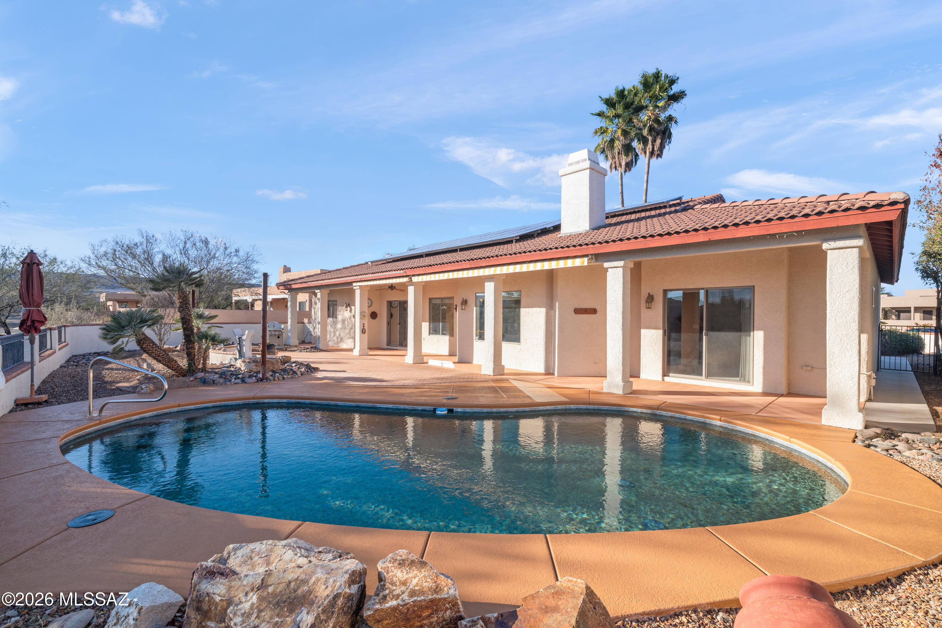 Discover peace and serenity in your new Portillo Ridge home! Entertain to your heart's desire in the private backyard pool and covered patio, equipped with Sunsetter shades. The kitchen is a showstopper with a beautiful Mesquite breakfast bar, a great island, and lots of storage.  Use the den as an office or hobby room, and the 3rd bedroom has a small, versatile room, as well for storage or supplies.  The main bedroom opens right out to the pool for that early morning swim.  Lots of space in this beautiful home to live exactly as you want to live. The (net meter) solar is owned and will be a very nice benefit to you.  A brand-new deep sink finishes off the laundry room on the way out to the spacious garage. This centrally located home provides quick access to stores, restaurants and I-19.