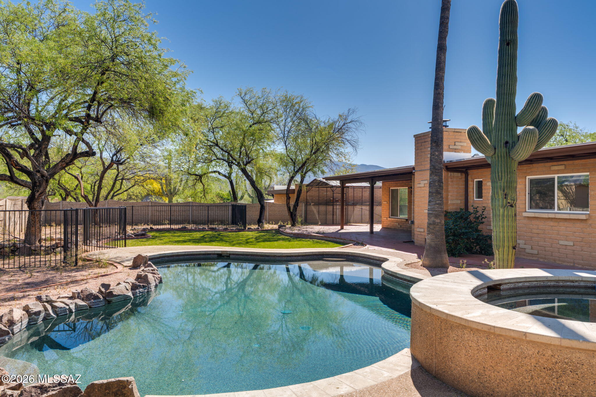 This large, updated family home on horse property is a rare find in coveted Tanque Verde Valley. Recent remodel includes new luxe vinyl flooring, new windows, lighting, fixtures, ceiling fans, fresh paint and so much more. New bathrooms and kitchen appliances. Four large bedrooms, 3 baths. Primary suite has sliders to pool/spa, patio. Fireplace in family room. Bonus room is separately heated/cooled and has private entrance - perfect for home office with lots of storage. Over an acre with custom pool and spa, artificial turf, mature trees and separately fenced horse/animal area with storage/barn. Plenty of space for your RV and all other toys.  Plus a separate aviary! Not to mention great mountain views from your patio, pool and spa.  All this and NO HOA!  New privacy fence north side.