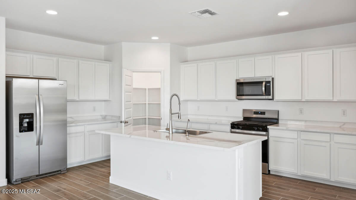 Welcome to your dream home in the desirable Saguaro Bloom community! This beautifully designed single-story home offers 5 generously sized bedrooms and 3 full bathrooms, perfect for families or those seeking extra space for guests or a home office. The open concept split floorplan features a bright and airy great room that seamlessly connects to the modern kitchen, complete with quartz countertops, stainless steel appliances, a large kitchen island and walk in pantry. Includes a three-car garage and is our most energy efficient home featuring spray foam insulation and is zero energy ready! Don't miss your chance to tour this amazing home!