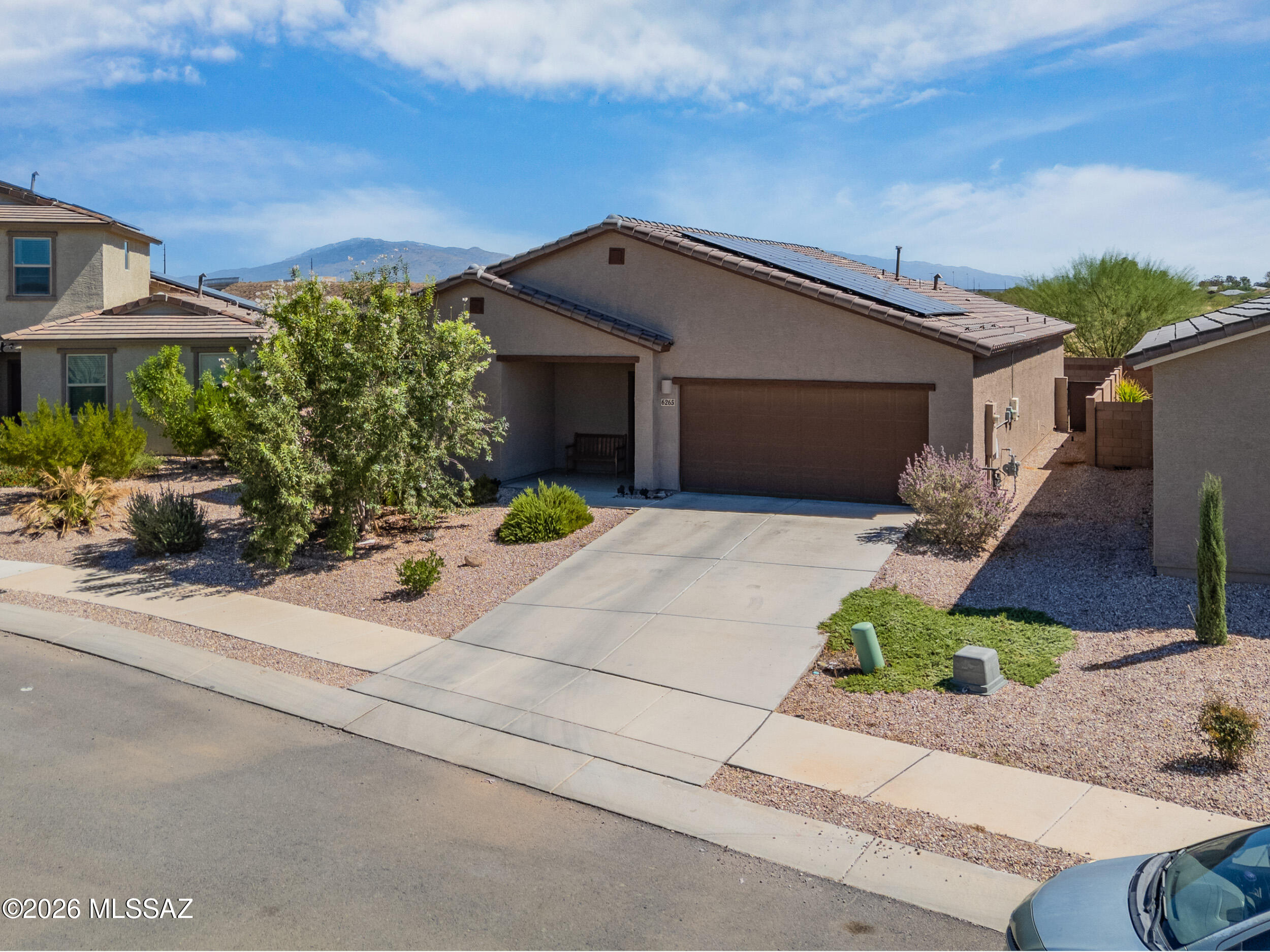 Welcome to this beautiful Lennar-built home in Tucson! This single-story 3 bedroom, 2 bath features a desirable split floor plan with tile throughout and carpet in bedrooms for comfort. The kitchen boasts upgraded granite counters and tall upper cabinets, perfect for storage and style. Relax in your backyard with serene desert views--no neighbors behind you. Leased solar panels help lower electric bills. Conveniently located near the I-10 for easy access around town, this move-in ready home offers both comfort and efficiency.