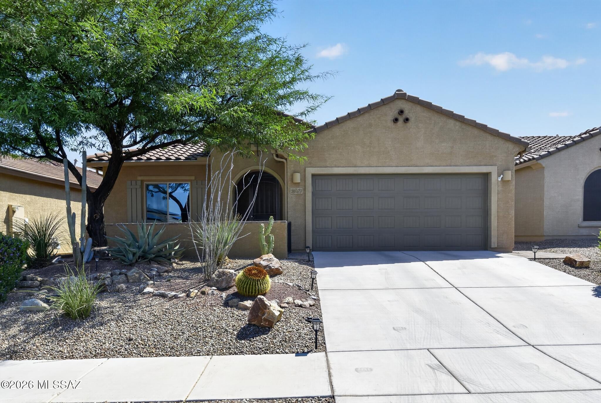 Beautiful like new 2BR+Den/2BA spacious Triumph model in 55+ Community of Del Webb at Rancho del Lago w/tile & plank flooring everywhere w/no carpeting. This Pulte built home on on a great lot w/no neighbors directly behind home has Rincon mountain view. North facing back patio w/synthetic grass & water feature. Front courtyard has some nice sunsets & is another nice hang out spot. Gourmet kitchen w/gas cooktop, quartz counters, tile backsplash, & large walk pantry. oversized extended  epoxy coated garage w/lots of storage space & room for a golf cart & workshop or craft area. Laundry room is good size w/sink & storage cabinets. Large entertainment center in great room w/electric fireplace. Primary BR w/bay window & view. This home is immaculate and well cared for in a great community.