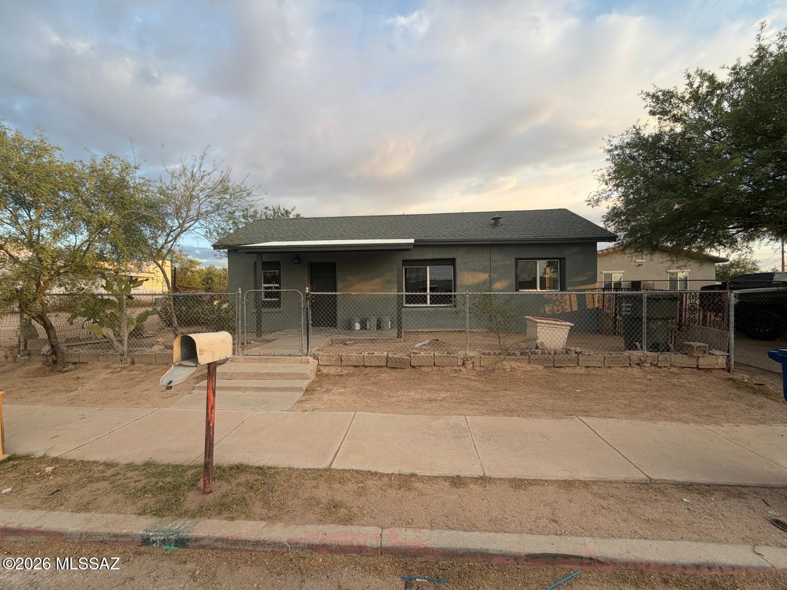 A very charming and updated adobe home!  This 2 bedroom, 1 bath and den has new dual pane windows, doors, new lighting,  fixtures, and  fresh interior/ext. paint.   New AC and roof in 2025.  The updated kitchen has new white cabinets, counters, pantry, and appliances.  Appliances will be installed before closing. Large laundry room with storage.  Huge fenced lot has great potential.  Close to downtown and I-10.    Seller will assist in buying down the interest rate.  Owner/Agent.