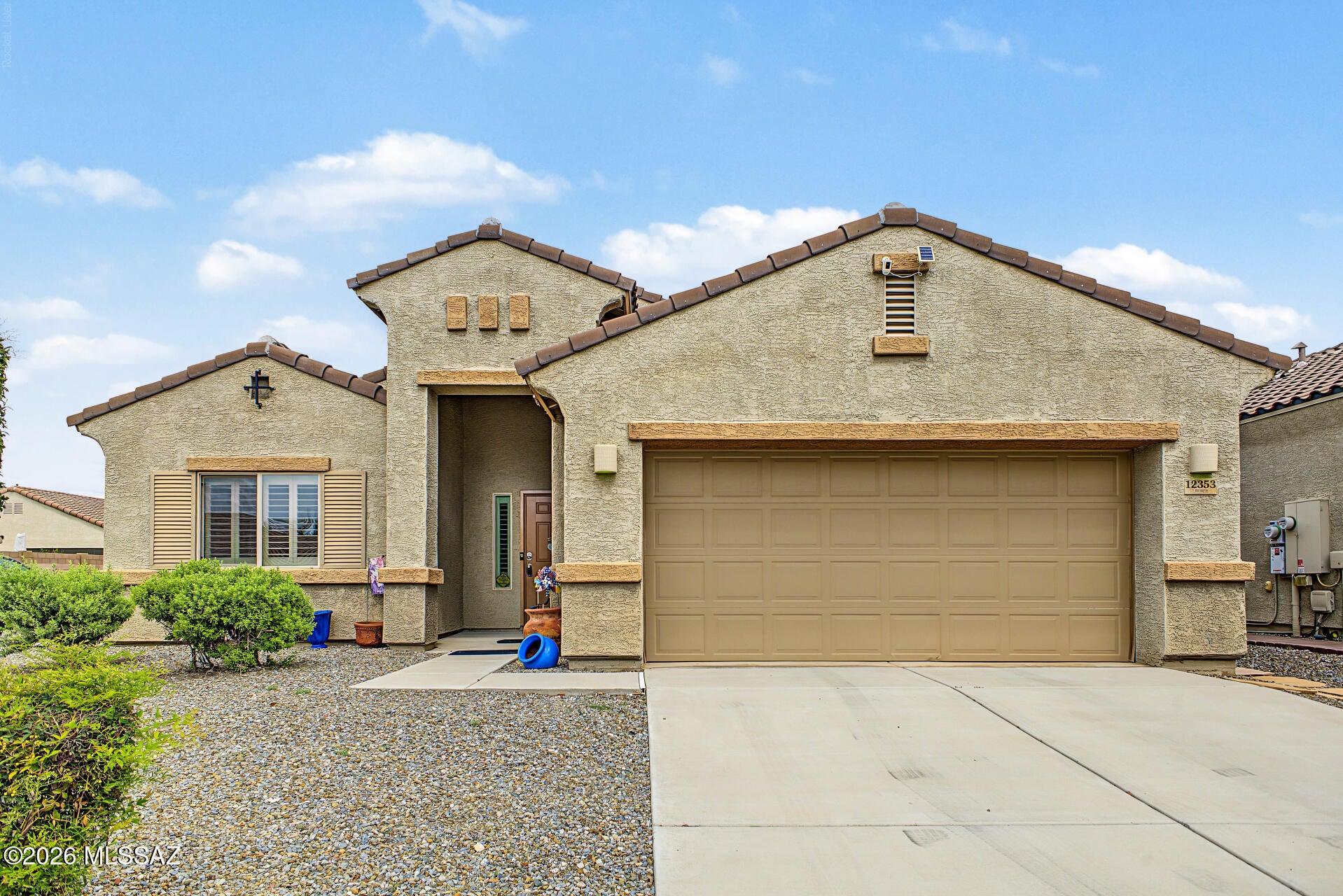 Spacious 3-bedroom, 2-bath home with a versatile den and 2,086 sq ft in the highly desired Vail School District! The open-concept layout features a functional kitchen with stainless steel appliances, plantation shutters, tile in the main living areas, and carpeted bedrooms. Enjoy the benefits of fully paid off solar, plus roll-in access, wide hallways and doorways for easy navigation. The garage offers added hanging storage, while the low-maintenance backyard features pavers and artificial turf. A spacious, flexible home with great features inside and out!