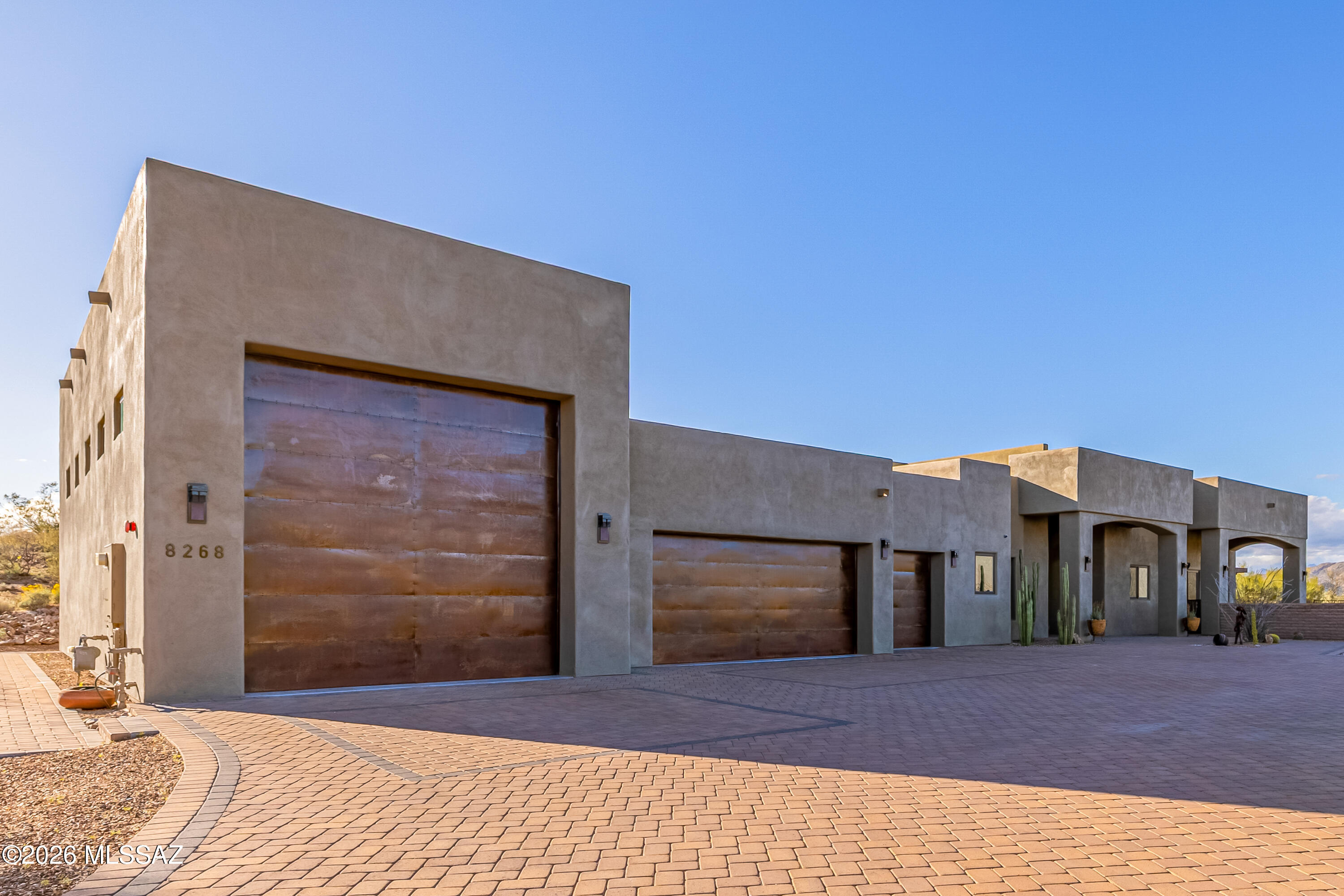 A stunning custom residence nestled behind the gates of the prestigious Coyote Creek community in Vail. Built in 2019 and thoughtfully designed to embrace the surrounding Sonoran Desert landscape, this home offers privacy, panoramic views, and a seamless blend of modern luxury and natural beauty.20' x 50' garage designed with RV owners, collectors, and hobbyists in mind, includes a 30-amp RV outlet, and an RV dump station. Step through the front entry and you are welcomed into an open-concept layout filled with natural light. Expansive windows and glass doors frame sweeping desert and mountain views. A beautifully appointed kitchen designed to impress. Solid wood cabinetry, rich granite countertops, and professional-grade appliances from Viking and Thermador. Elevate the culinary experience, ensuring performance meets elegance. Upstairs, lays the primary suite offers a private retreat designed for relaxation. A private patio extends from the suite, overlooking the sparkling pool and outdoor kitchen area below. The outdoor living areas designed to maximize Arizona's year-round sunshine. The covered patio is equipped with ceiling fans, an outdoor television, and a complete sound system. The outdoor kitchen features both a gas grill and a Santa Maria-style wood-burning BBQ. A custom gas fire pit creates a warm and inviting focal point for evenings under the stars. Residents can enjoy the exceptional amenities of Coyote Creek. This master-planned community offers an equestrian center, recreational facilities, parks, ball courts, and scenic walking and riding trails. The gated setting provides both security and serenity while preserving the natural desert environment that makes Southern Arizona so desirable.