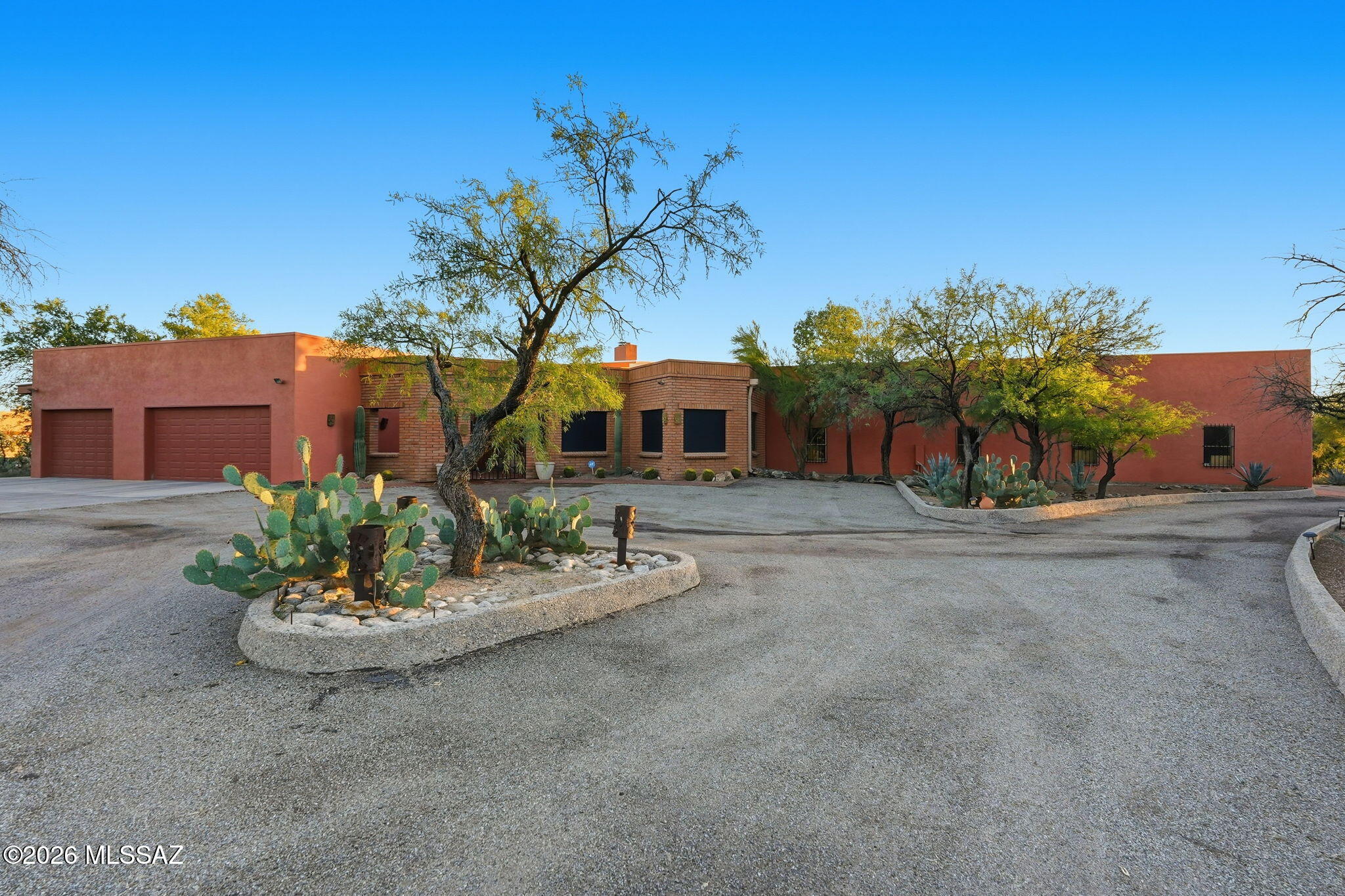 On a corner lot in  the heart of Northwest Tucson, this 2.36-acre retreat invites you to spread out, dream big, and finally find a home for all those hobbies you've dreamt about. Electric gate entry, tranquil courtyard, 4 bedrooms, 4 bathrooms, split floorplan 2 ensuites, 2 fireplaces, walk-in pantry, huge laundry room,  a striking wall of windows frames sweeping mountain views from the living room with a classic rock wall fireplace anchoring the space with timeless character. The custom bar is perfect for happy hour charcuterie time or honing your inner barista skills! Outdoor living is the headliner. Naturally shaded at the best times of the day, the pool was freshly replastered in 2024 and pairs with generous covered patios for effortless desert entertaining. The attached three-car garage and a remarkable eight-car workshop with evaporative cooling, a full bathroom, washer/dryer hook ups presents options for a home-based business or serious tinkering. Horse lovers will appreciate the room to roam, too. Recent upgrades include a newer roof, fresh rain gutters, sunscreens and HVAC. The neighborhood delivers, with Ironwood Ridge High School, West Lambert Lane Park, grocery options, and convenient transit all within easy reach.
This could be the one you've been looking for!