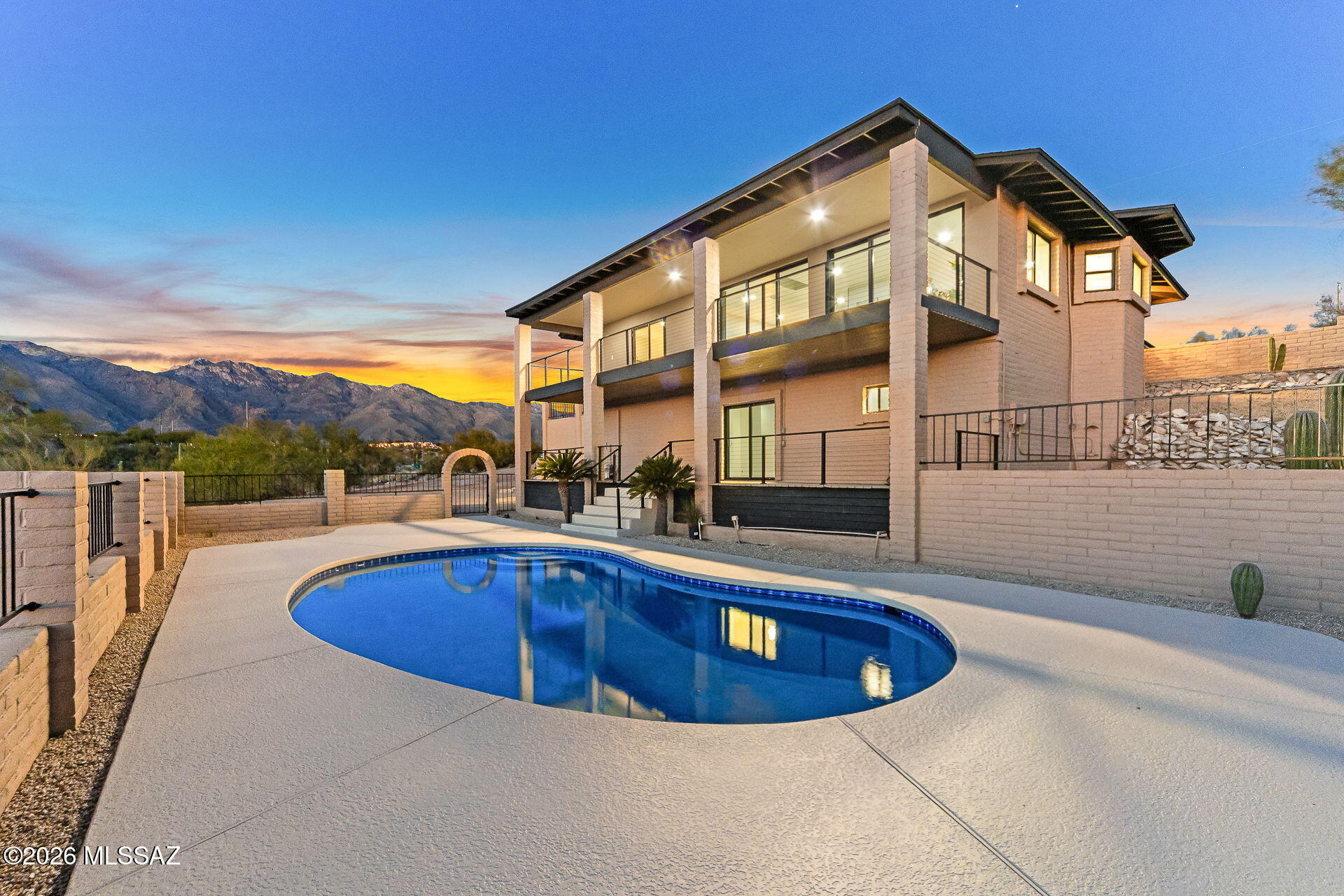 Welcome Home! This fully refreshed Foothills view residence delivers an immediate sense of wow--clean architectural lines, warm modern finishes, and expansive views that seamlessly blend elevated living with the beauty of the pristine Sonoran Desert!

The heart of the home is a light-filled great room anchored by a stylish fireplace, flowing effortlessly into a showpiece chef's kitchen featuring leathered quartzite countertops, custom cabinetry, and premium ZLINE appliances--designed for both everyday living and effortless entertaining! Floor-to-ceiling walls of sliding glass open the home to the outdoors, framing big-sky vistas, mountain backdrops by day, and glittering city lights by night.

Upstairs, the primary suite is a true retreat, offering private view-deck access and a