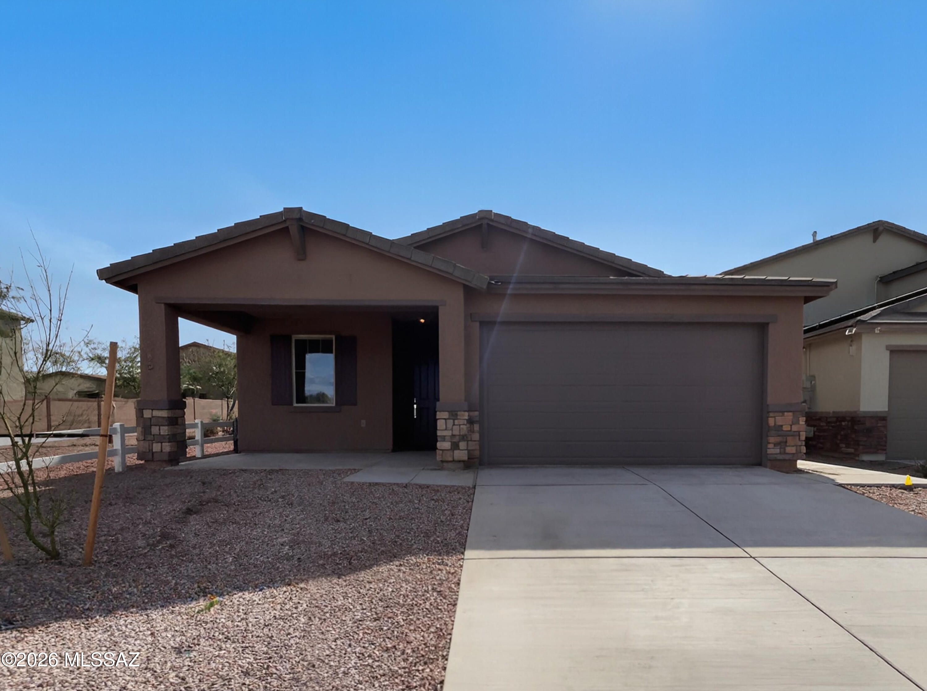 Welcome to this spacious 4 bedroom, 3.5 bath home with a 3-car tandem garage in the vibrant Gladden Farms community in Marana - perfectly designed for flexible lifestyles and multigenerational living. A dedicated NextGen suite exceptional with its own entrance, living room, kitchenette, bedroom, bathroom, and laundry making it ideal for extended workspace. A well-appointed kitchen with granite countertops, stainless steel appliances, and great flow for everyday living and entertaining. A versatile space provides the perfect spot for an office, playroom or hobby area. Upstairs, a loft adds even more room to relax, along with three additional bedrooms and a second laundry room. Enjoy the beauty of the Arizona desert with year-round outdoor recreation, gorgeous sunsets, and towering saguaros.