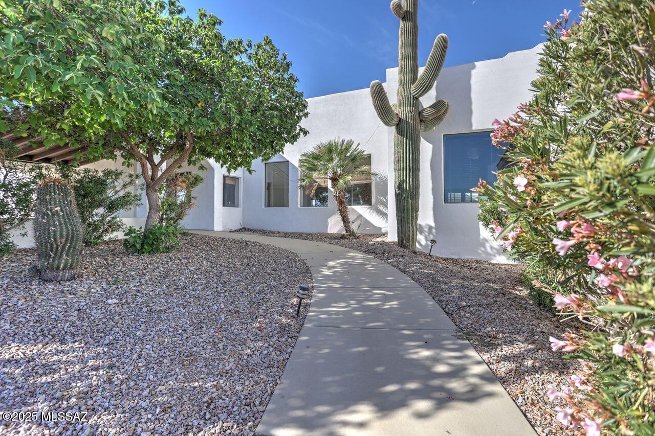 Check out the price per square foot on this  Private Gorgeous hilltop home with panoramic views!   Every square foot of this 5328 sq ft home is beautiful, w/marble floors, granite counters, interior pillars and Spacious Rooms.  Four bedrooms, three of those are huge primary ensuite bedrooms, two with large custom walk-in showers and separate tubs. Two front entrances into home, one into a large foyer, and one from the beautiful covered patio.  The 3000 sq ft detached garage built in 2016 with three 12'  x 14' garage doors is every car enthusiast, builder or mechanics dream garage, with 200 AMP electric, water, Evaporative cooling AND Heat Pump for AC/Heat. Room for 10 cars, or even RV's and cars. Extensive remodeling on house was completed a few years ago, and has been maintained well. Two electric gates, one at the road and one at top of the hill into the fenced yard. Solid Masonry home built to last.
Both wings of the home are handicapped accessible by ramped sidewalk and zero clearance front doors. Both primary suites showers are also walk-in/roll-in accessible. Solar is paid off.  Pool has been resurfaced.  Pool maintenance and yard maintenance will be completed soon.
PRICE REDUCTION!!