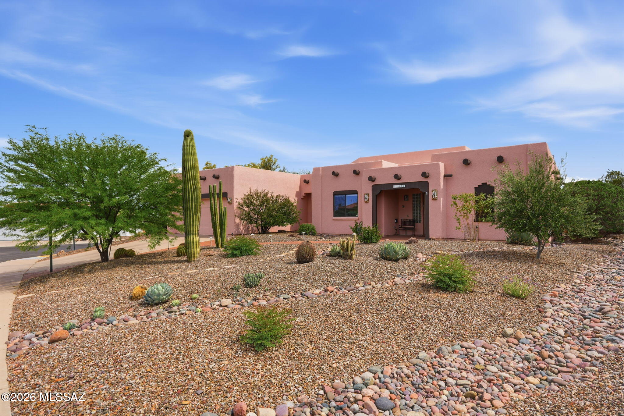 Nestled in the centrally located and peaceful community of Portillo Hills, this beautifully updated Santa Fe-style home offers the perfect blend of Southwest charm and modern comfort. Designed with an open, airy floor plan, the home features low maintenance flooring throughout. At the heart of the home, the fully renovated kitchen is a standout, showcasing sleek quartz countertops, stainless steel appliances, custom tile backsplash and a contemporary induction cooktop, set up for both everyday living and entertaining. The spacious living room impresses with soaring 12-foot ceilings and expansive windows that flood the space with natural light, seamlessly connecting indoor and outdoor living. Step outside and discover the professionally designed landscape. New HVAC! New South facing windows This lovely home is ideal for those who appreciate the beauty and simplicity of desert gardening. Whether hosting guests or enjoying a quiet morning, it offers a relaxed yet refined lifestyle in one of Green Valley's most desirable neighborhoods. Plus there's a bonus-a new HVAC April 2026 and new windows on south-facing back of house. Take a look! You'll feel like you're living in a private oasis!