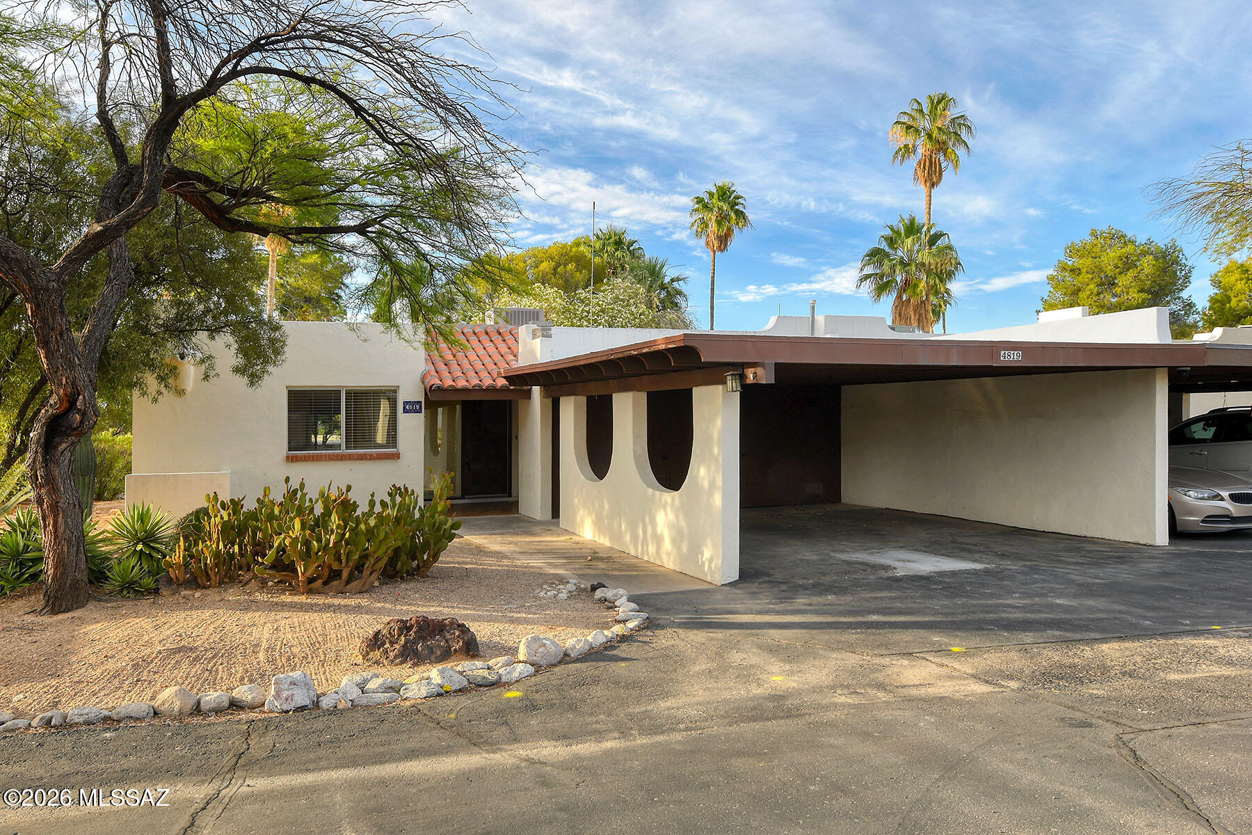 Discover the perfect blend of convenience, comfort, and tranquility in this beautifully maintained 3-bedroom, 2-bath townhouse offering 1,599 sq. ft. in Tucson's sought-after Catalina Foothills. Ideally situated on desirable Via Entrada near the Tucson Loop bike path and River Road, this single-level home provides easy access to shopping, world-class dining, and entertainment while still offering exceptional privacy and peaceful surroundings.  Inside, you'll find a warm and inviting living and dining area centered around a classic beehive fireplace, creating the perfect ambiance for relaxing or entertaining. The home features ceramic tile, bamboo flooring, or brand-new carpeting throughout, along with freshly touched-up paint that enhances its move-in-ready appeal.  The updated kitchen combines style and functionality with designer countertops, newer cabinetry, and stainless steel appliances. The spacious primary suite includes multiple closets and an en-suite bathroom with a beautifully remodeled shower.  Additional highlights include a two-car carport and generous storage space in both the front and rear patio areas. Step outside to the expansive covered patio, ideal for outdoor dining, entertaining, or simply enjoying Tucson's beautiful weather while overlooking the nearby community pool, heated for 10 months of the year and close enough for convenience without the added noise.  Thoughtfully upgraded and impeccably cared for, this serene Tucson retreat is ready to welcome you home!