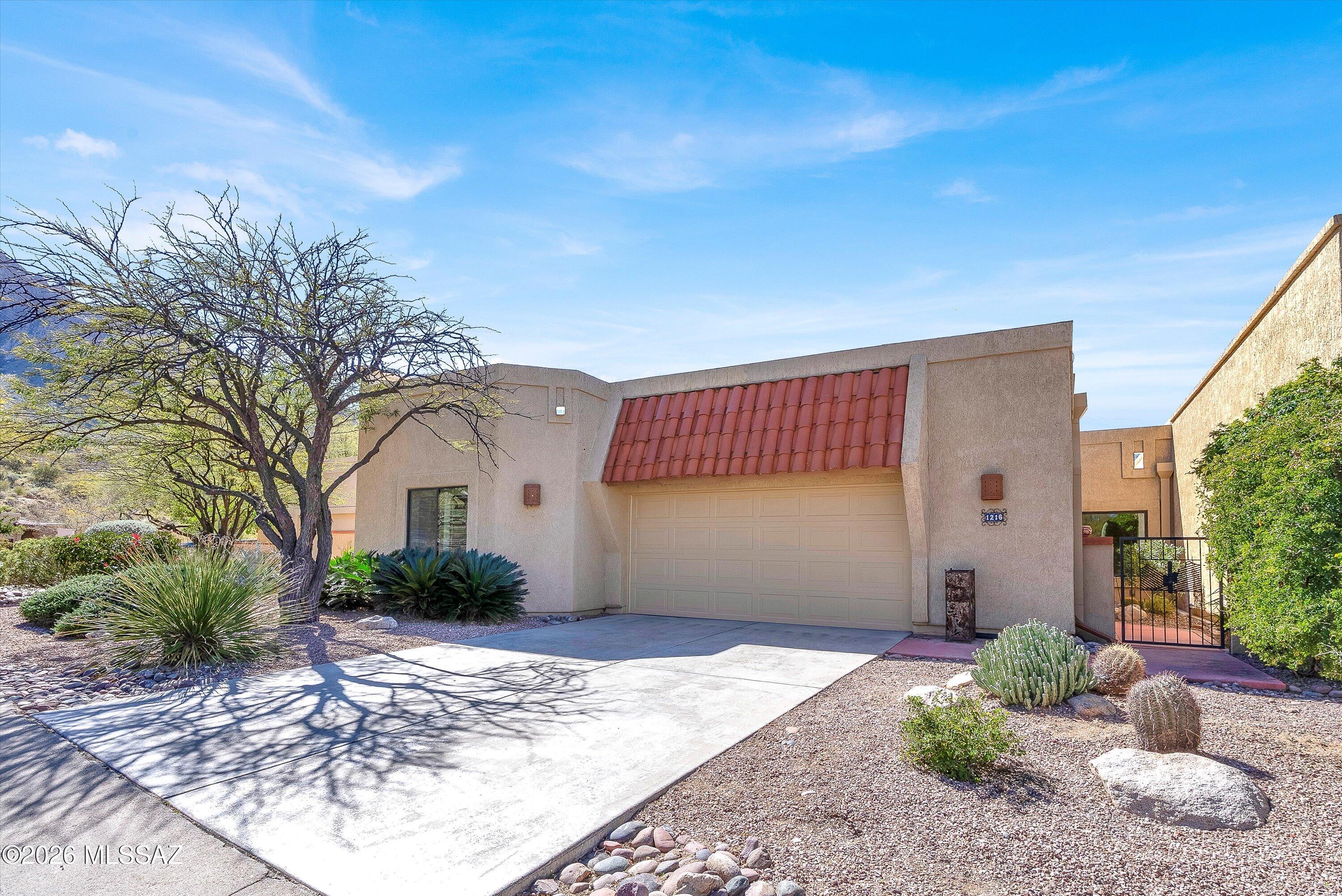 Welcome to this charming 3BD, 2BA, El Conquistador Patio Home offering 1,646 square feet of thoughtfully designed living space and timeless Southwestern flair. Enter through the inviting courtyard and step into a warm, welcoming living area highlighted by a charming fireplace -- the perfect setting for cozy evenings. The adjoining dining room flows seamlessly into the kitchen, where stainless steel appliances, a cozy breakfast nook, ample cabinetry, and direct patio access make both everyday living and entertaining effortless. The spacious primary suite is a true retreat, featuring private patio access and a spa-like bath complete with a relaxing soaking tub. A desirable split floor plan provides added privacy for guests, with a full hall bath.The second guest room, currently used as a den or office, showcases double glass French doors and can easily be converted into a third bedroom to suit your needs. Step outside to an extended paver patio designed for enjoying Arizona's breathtaking desert landscape. Capture stunning mountain views along with vibrant sunrises and sunsets or relax while overlooking the golf course. This outdoor space is ideal for entertaining or simply unwinding in peaceful surroundings. All of this is conveniently located near golf, dining, and shopping offering the perfect blend of comfort, charm, and lifestyle.
