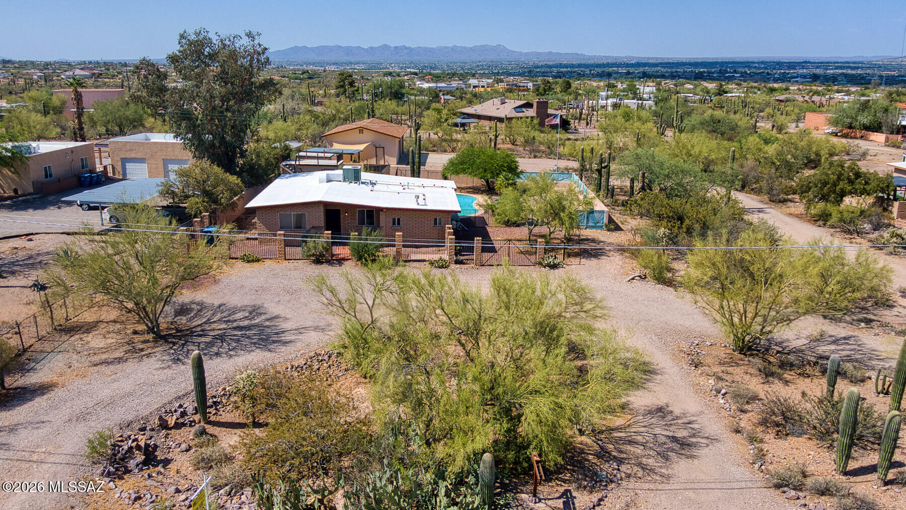 Come see your country paradise.  Plenty of room and privacy. This sanctuary provides unmatched privacy, efficient accommodations, ample shop workspace, and a serene undisturbed Sonoran desert landscape. The unique elevation allows for panoramic views of Catalina/Tortolita Mountain Ranges, picturesque sights of Monsoon approaches, and wide-open dark skies for fireside stargazing. You will truly experience the joys of a relaxed rural lifestyle, albeit within minutes of modern conveniences. 

This 1.1 acre property includes (36) Saguaros, 0.25 acre fully fenced yard, 25000 gallon pool, lemon/lime trees, 350 sqft enclosed storage space, 450 sqft covered parking, 500 sqft paved approach, and 1200 sqft swamp cooled shop. Home was remodeled in 2018 including all new cherry wood cabinets, granite countertops, stainless steel Maytag appliances, gas fireplace, resurfaced pool, and sand filter/pump. The surrounding neighborhood boasts miles of paved trails thru a classic Southwest landscape for endless morning/evening walks.  No HOA allows for customized architecture and even an outdoor art gallery within the community. 

Rest easy knowing that that this westside hub provides easy access to Old Pueblo staples including Saguaro National Park, Arizona-Sonora Desert Museum, Sweetwater Trailhead, Starr Pass, University of Arizona, Downtown, and arguably the best Sonoran food in the country. Proximity to Silverbell Road also allows for alternative I-10 travel, with multiple routes available to avoid congestion. 

The only thing missing is you!