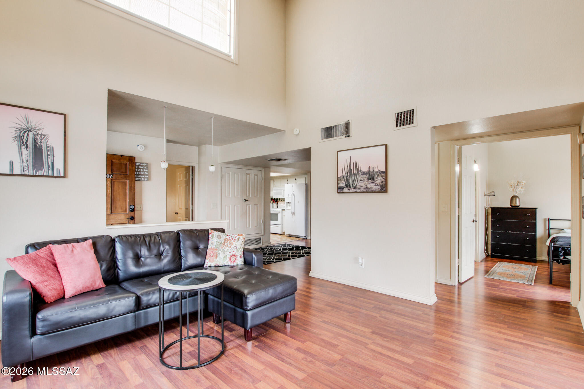 Charming move-in ready 2-bedroom, 2-bath condo in the heart of Oro Valley! Currently operating as a successful short-term vacation rental and available fully furnished, this turnkey property is ready to go. Vaulted ceilings and skylights fill the home with natural light, while the split-bedroom floor plan offers privacy with full bathrooms for each suite. The inviting living room features a beautiful beehive fireplace and double patio doors creating seamless indoor/outdoor living.  Enjoy peekaboo mountain views from the patio.  A cozy office nook.  Newer HVAC, water heater and updated tile showers make this truly move n ready. Low-maintenance condo living just steps from Trader Joe's, shopping, and great restaurants.