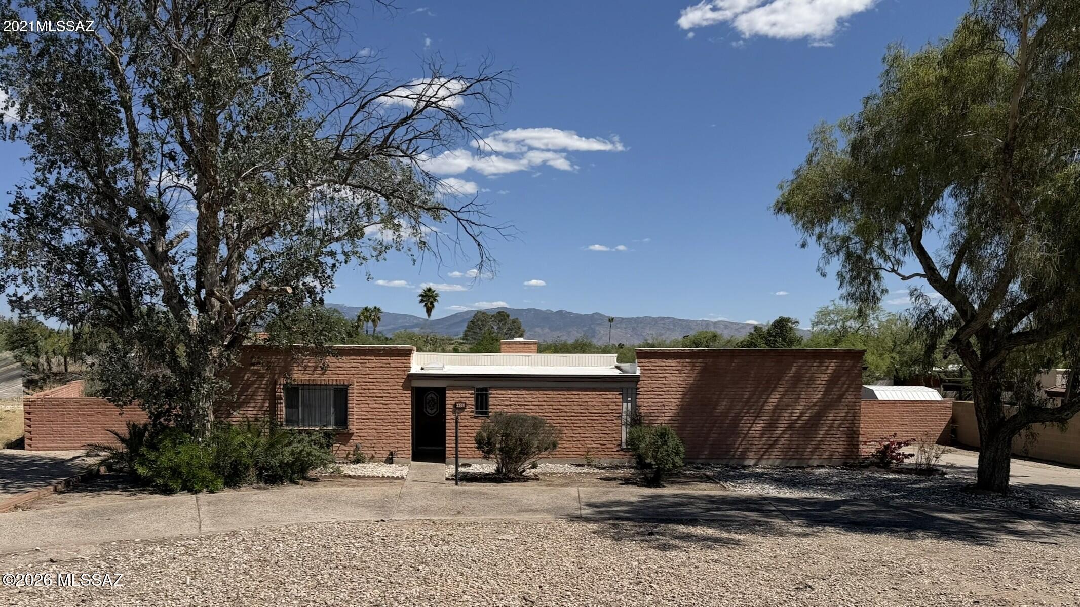 Spacious 5-bedroom, 2.5-bath home on a large lot in desirable Northeast Tucson. Enjoy mountain views and a sparkling pool, perfect for outdoor living. Interior features parquet wood floors, tile throughout, and no carpet. Kitchen includes newer stainless steel appliances. Freshly painted interior. Separate living and dining areas plus a comfortable family room with fireplace provide flexible living space. Competitively priced and ready for its next owner and their personal touches, with ample natural light and room to spread out, inside and out.